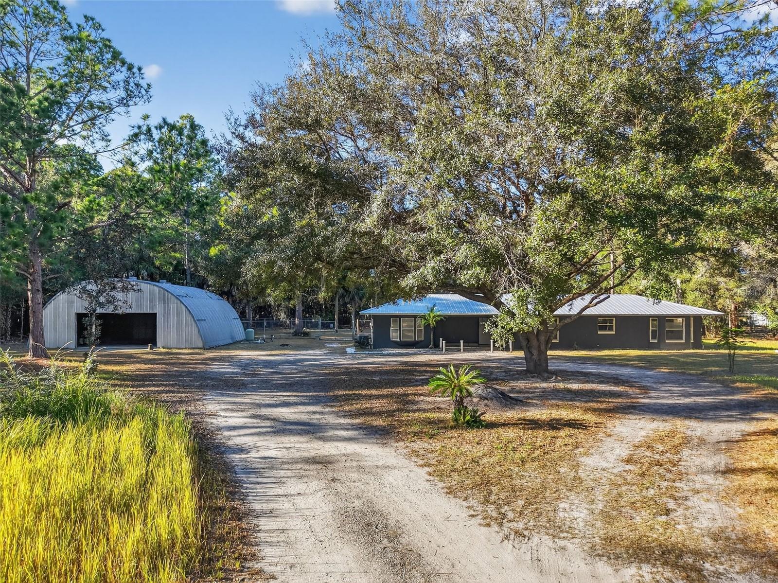 Welcome to 2110 Warrensford Road, Pierson, Florida! Set on 10 acres in a peaceful rural setting, this property offers 2,382 square feet of living space and a rare combination of privacy, functionality, and modern updates. Just minutes from local shopping, restaurants, and everyday conveniences, it provides the perfect balance of country living with accessibility to essential services. The home has been thoughtfully maintained and improved, featuring a metal roof installed in 2021, a new AC system on the primary side (2024), and a water treatment system with a new well pump (2024). High-speed Spectrum fiber internet ensures reliable connectivity, making it ideal for remote work, streaming, or online learning. This property is designed for versatility. A 40x36 steel frame structure provides ample space for storage, workshop activities, or hobbies, while a 24x12 greenhouse is perfect for gardening or small-scale agricultural projects. The above-ground pool with deck offers a private area for relaxation and entertaining. Extensive brush clearing, tree removal, and debris cleanup have been completed, maximizing the usable land and enhancing the property’s overall appeal. The 10-acre lot allows for a wide variety of possibilities, including outdoor recreation, gardening, hobby farming, or future expansion. With functional structures, cleared acreage, and modern utilities already in place, this property provides a rare opportunity in Volusia County for buyers seeking space, convenience, and versatility.