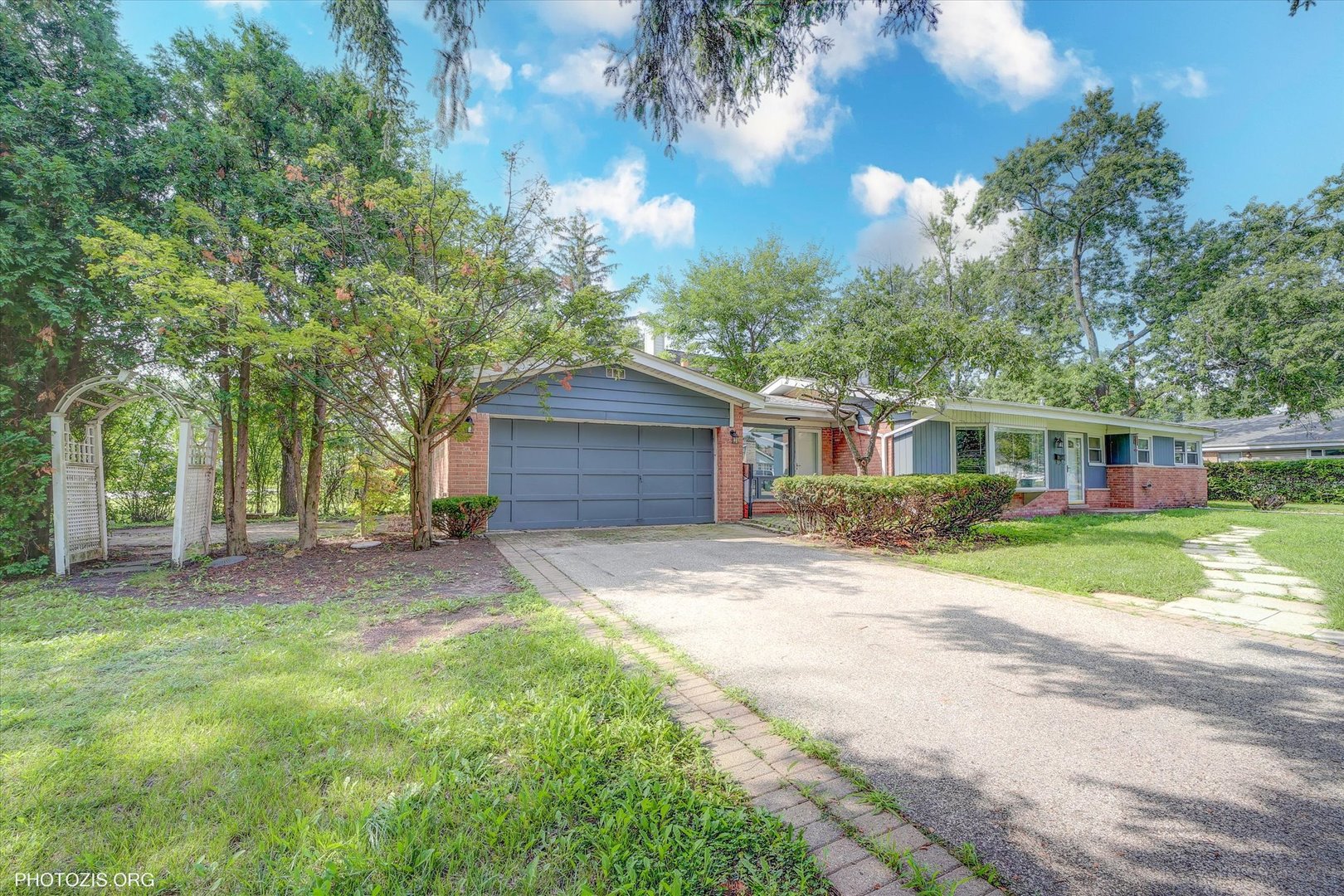 Beautiful Brick Ranch on a Spacious Corner Lot  with Attached 2 Car Garage.  Move-In Ready!  Welcome to this stunning brick ranch home nestled on an oversized corner lot, offering comfort, charm, and modern updates throughout. The spacious living room features vaulted cathedral ceilings and a large bay window that fills the space with natural light.  The beautifully updated 2024 kitchen showcases brand-new cabinets, quartz countertops, stainless steel appliances, and new flooring, complemented by a lovely greenhouse window. A cozy family room with a wood-burning fireplace adds warmth and character-perfect for relaxing evenings.  This home offers three generously sized bedrooms and updated two full bathrooms, ideal for comfortable family living. Step outside to a large backyard patio surrounded by mature trees-your own private oasis, perfect for outdoor entertaining.  Additional highlights include:  New roof (2019)  HVAC (A/C. Water Hear. Heating) less than 3 years old. Washer & Dryer 2 Years Old  Room for future expansion on this large lot. Highly rated school district  Move-in ready  in excellent condition-don't be fooled by the "AS IS" listing! A true gem that combines modern updates with timeless charm.