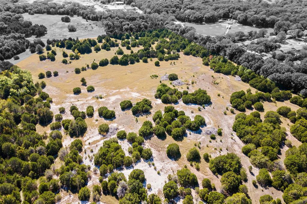 In the Hill Country of Dallas lies 45 undeveloped acres of Texas-size open space, offering a perfect blend of quiet country living with all the conveniences of a premiere city. Most of the land is currently zoned SF-22 while a smaller portion is zoned RR, ideal for a premium development. The land is directly adjacent to the site of a planned 200+ acre Cedar Hill park and is currently the largest amount of acreage for sale in the city. Currently being leased for cattle grazing, the acreage is AG exempt with a tax bill of less than $100. A main water line is installed at the S Clark gate entrance. Another gate is located on Stoney Creek with private road access. 1600+ road frontage off S Clark, 375+ road frontage off Stoney Creek. Elevation at the northeast side is at its highest providing spectacular views. A creek runs through the property, pecan & peach trees are located at the southeast corner, & bluebonnets are located at the southwest portion. Horse stables & a large park with a walking trail are across the street on S Clark, Plummer Elementary adjacent to the north, with the Cedar Hill Fire Station at the corner. Current permitted by right usages include but are not limited to private country club, golf course, non-commercial radio tower & a church.