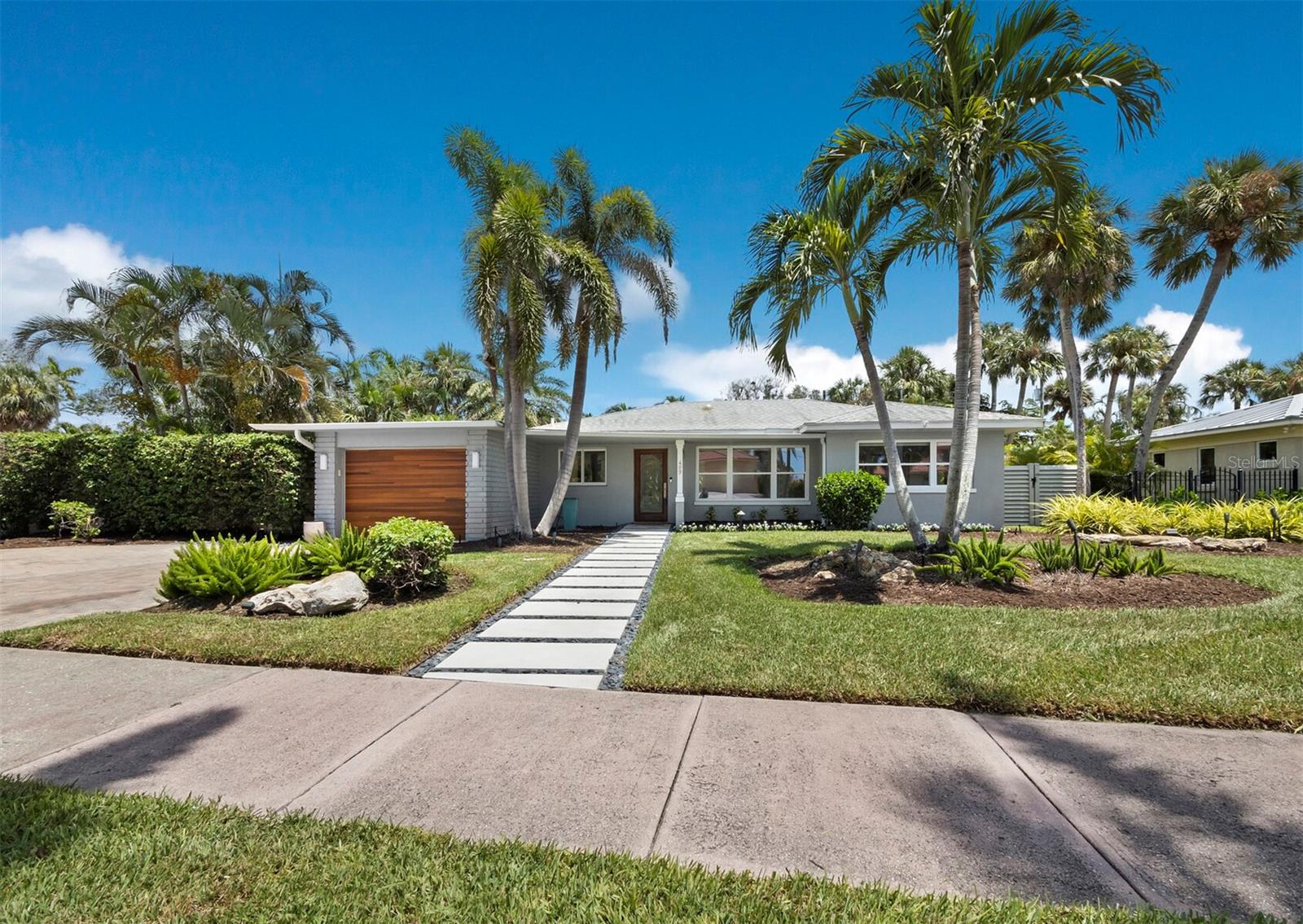 MOVE IN CONDITION - just completed remodel and restoration.  Cute and clean 2/2 spacious contemporary bungalow steps away from Lido Beach and St. Armands Circle, no driving or parking necessary.  Following the plans of Sarasota designer Sam Dickson, the house was completely remodeled and restored in 2018 to update its 1950 origin.  In 2025 the home has been restored and remodeled adding space to the master bath and laundry room layout.