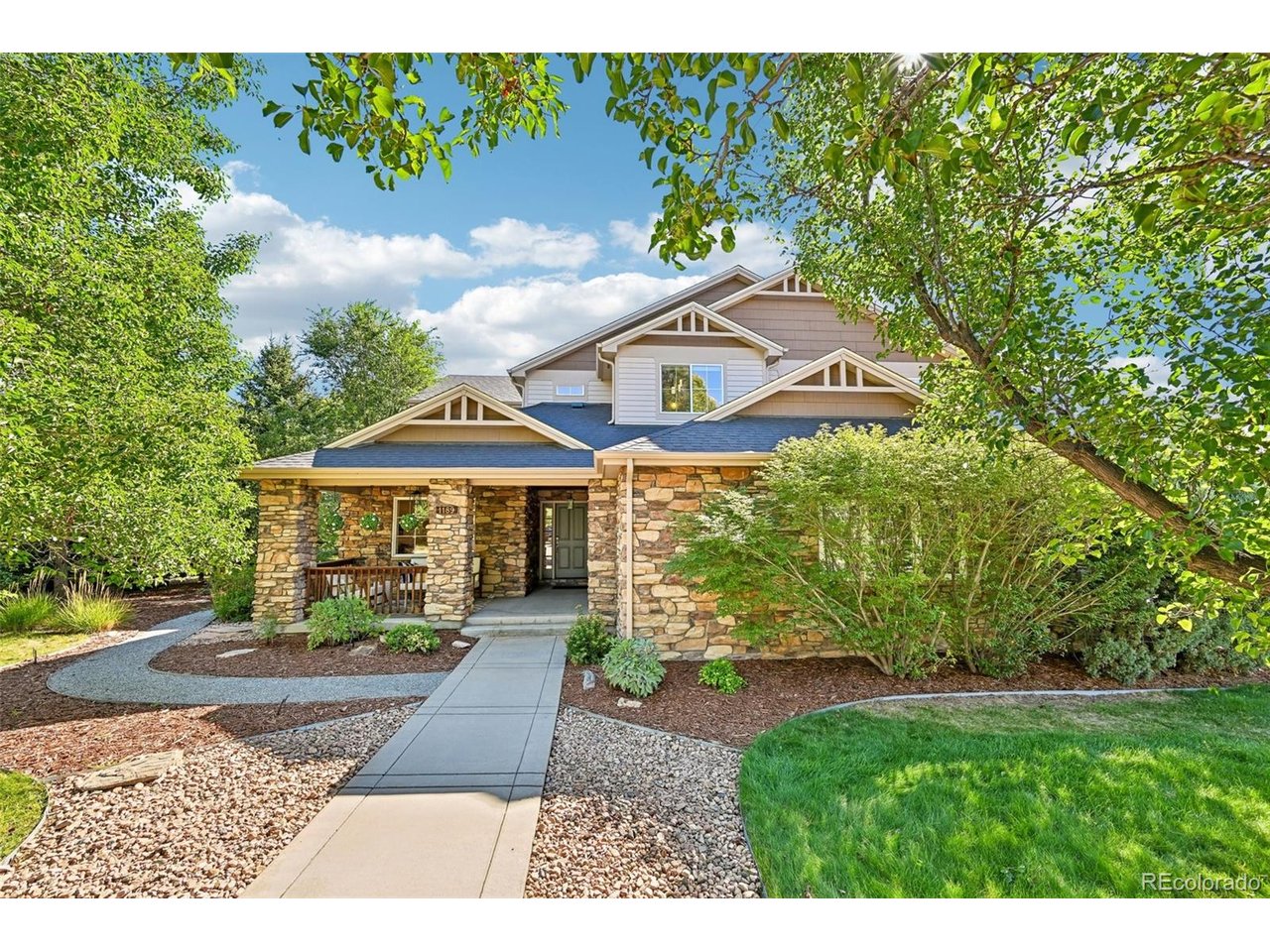 Space to gather. Privacy to unwind. Possibility to grow. Tucked into a quiet Lafayette neighborhood near trails, this 5-bedroom, 4-bath custom home offers flexible living & a garden-inspired Colorado lifestyle. A welcoming front porch invites morning coffee and relaxed evenings. Inside, wood floors connect the formal living and dining rooms to the heart of the home. Expansive east-facing windows fill the kitchen, breakfast nook, and family room with natural light. The kitchen features an induction cooktop, KitchenAid refrigerator, GE oven and microwave, abundant cabinetry, new quartz countertops, a walk-in pantry, & a butler's pantry. A main-level bedroom and adjacent three-quarter bath offer flexibility for guests, multigenerational living, or a private office. Upstairs, 4 bedrooms include a spacious primary suite with a gas fireplace, window seat, oversized walk-in closet, soaking tub, separate shower, & individual vanities. A second ensuite provides privacy, while two bedrooms share a Jack-and-Jill bath. Outside, discover a garden lover's retreat with approximately 30 established trees, including fruit trees, plus grapevines, raspberries, strawberries, herbs, & other edible plantings. The kitchen patio has a gas line for grilling and an inviting setting for outdoor dining. Beside it, a tranquil water feature creates the soothing sound of flowing water, a peaceful backdrop for coffee or evenings outside. The unfinished 1,737-square-foot basement with 9-foot ceilings is ready for storage, a gym, recreation space, or future expansion. An oversized 3-car garage & updates, including the roof, appliances, flooring, lighting, radon mitigation, epoxy garage floor, and two new water heaters, add comfort and confidence. Enjoy nearby trails toward Old Town Lafayette & the shops and restaurants along Highway 287, with convenient access to Boulder & Denver. A home designed for the way you live today, with room for everything that comes next.Learn more at 1189HawkRidge. com