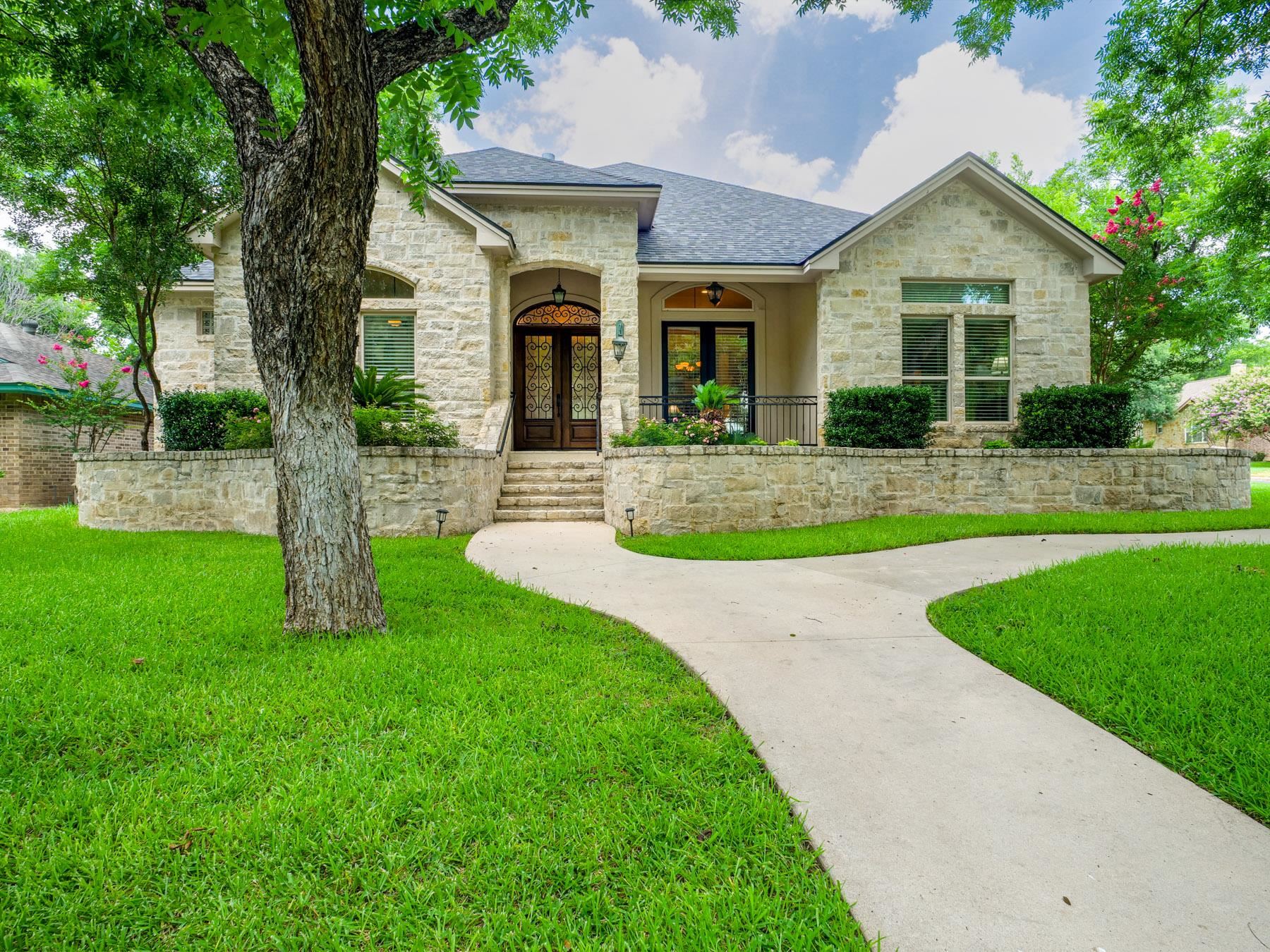 Enjoy this custom-built home on a spacious corner lot surrounded by beautiful pecan trees in the gated community of Meadowlakes. This thoughtfully designed home features an open-concept floor plan with an expansive living room that flows seamlessly into the spacious kitchen, creating the perfect space for entertaining and everyday living.  The home offers two eating areas, including a bright breakfast nook and a formal dining room for special occasions. A dedicated private office provides an ideal space for working from home or managing daily tasks.  The oversized primary suite is a true retreat, featuring separate his-and-her bathrooms for added privacy and convenience. A large side-entry garage includes a dedicated golf cart storage area and connects to the home through a covered breezeway, with an additional covered patio for relaxing outdoors.  Located just a few blocks from the private Meadowlakes dock with access to Lake Marble Falls, this home also offers access to the outstanding amenities of Meadowlakes, including the city-owned Hidden Falls Golf Course, an on-site restaurant, tennis courts, a POA park, and lake access. This exceptional property combines comfort, convenience, and an outstanding lifestyle in one of the area's most desirable communities.  Recent updates include hardwood flooring in all the bedrooms, new composition roof, and freshly interior painted thoughout, including the including the garage.