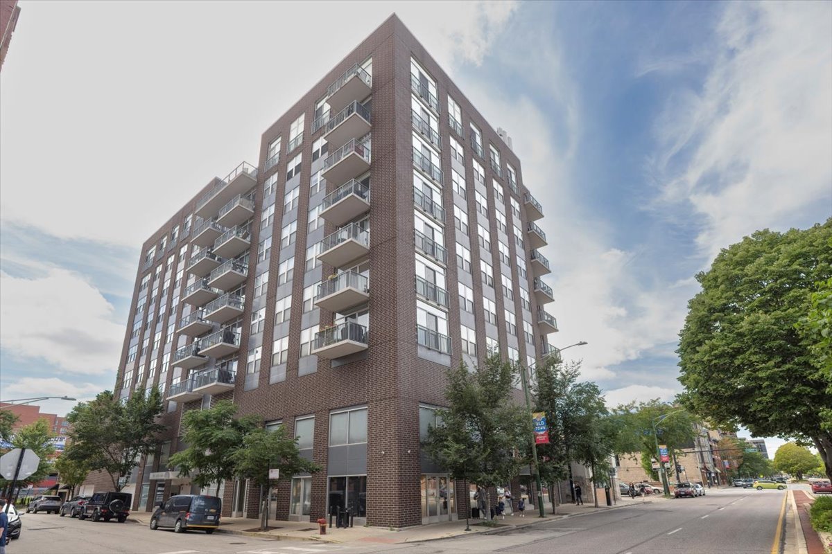 A rare opportunity in the heart of Old Town - this corner residence offers 2 bedrooms, 2 baths, and an effortless blend of comfort and style. Steps from Wells Street and the Brown/Purple Line, the home is perfectly positioned for both neighborhood charm and city convenience.    Inside, newly installed red oak hardwood floors run throughout an open, flowing layout. The split-bedroom design ensures privacy, while the kitchen - complete with breakfast bar and stainless appliances - opens seamlessly to the living and dining areas. A fireplace adds warmth and character to the main living space.    Flooded with natural light from its southern exposure, the home extends outdoors to a remarkable 320 sq ft balcony with sweeping views of downtown. Originally configured as a 3-bedroom, the floor plan offers the flexibility to reconvert if desired. Three-plus garage parking spaces are included in the price. Move-in ready. Assessments incl. heat, internet & cable TV