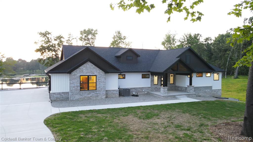 Almost Done! Now is the Time to Make It Yours!

This stunning, custom-built home is nearly complete and ready to impress, with over 540 feet of private lake frontage on scenic Lake Lochmoor. Set on nearly 2 acres at the end of a quiet cul-de-sac, it’s a peaceful escape with space for private trails and sunset views.

With 5 bedrooms and 3.5 baths, the home blends elegance and function. A covered front porch welcomes you, and the Trex deck is ideal for enjoying lake views.

Inside, the open-concept layout is filled with natural light from Andersen windows and flows into the finished walkout basement. Expansive windows wrap the lower level, showcasing the outdoors from every angle. This bright, airy space feels like a continuation of the main living area, fully connected to the lake and landscape.

The great room features vaulted ceilings with beams, a fireplace, and recessed lighting. The kitchen includes Quartz counters, a 48-inch gas stove with hood vented outside, and a grand island. The main-floor primary suite offers dual walk-in closets, double vanities, and a spa-style shower. Two additional bedrooms share a Jack and Jill bath.

Main-level features also include a mudroom, half bath, and spacious laundry room.

The walkout basement includes a rec area, game room, two bedrooms, full bath, and ample storage. A wet bar or second kitchen is roughed in—perfect for guests or an in-law suite.

The oversized 3+ car garage is fully insulated, drywalled, and includes openers. All located in a quiet, paved neighborhood just 6 minutes from I-96, with access to Ann Arbor, Lansing, and Metro Detroit.

More than a home—it’s a lakeside lifestyle crafted with light, quality, and natural beauty.

Please note: Exterior photos show the actual home. Interior photos are from past builds by the same builder with similar layouts and finishes.