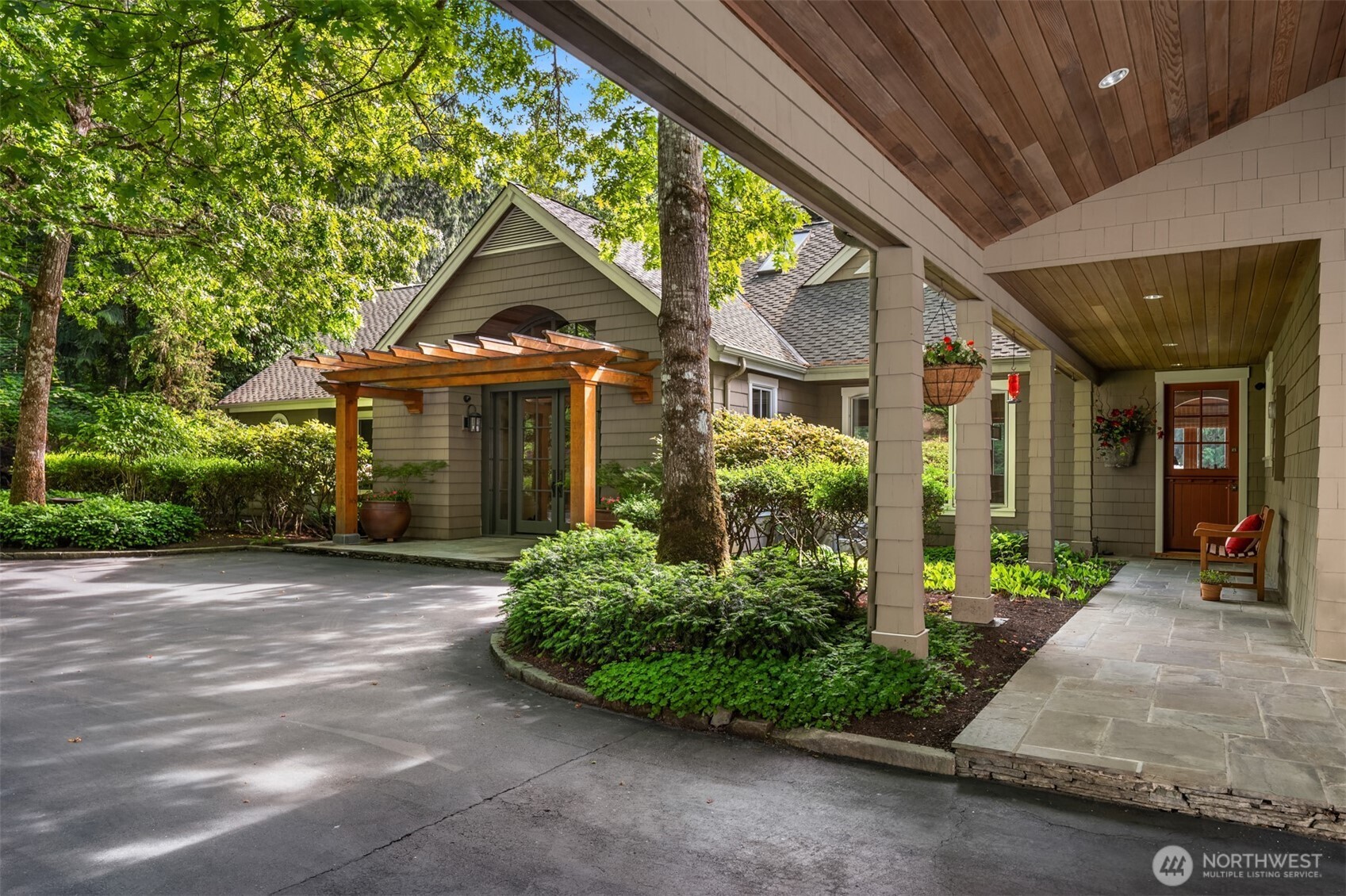 Front entry with wood pergola, glass door, covered porch