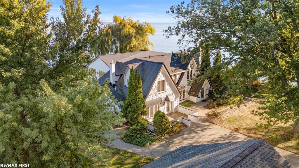 What an opportunity to purchase one of Macomb county's most iconic home and property!! One of a kind .75 acre of peninsula paradise with over 135ft  of prime lake frontage on beautiful Lake St., Clair. ( Buyer to verify all measurements).  You will be awed when you arrive at this 3850 sq ft vintage home in wonderful condition. New paint and carpet thru-out. Gourmet kitchen with custom Amish cabinetry, granite counters, high end appliances. Full glass breakfast nook with sweeping 180 degree view of the water. Spacious formal dining room with bar, First floor office w/fireplace would make a nice primary bedroom. The 26x21 Primary suite boasts  floor to ceiling windows for you to enjoy the fabulous sunrises and romantic moonglows. Door wall leads to a 22x9 maintenance free deck with glass knee walls to keep your view pristine. The Primary also features two 1/2 baths plus additional tub and  shower area for ultimate in privacy and flexibility. 15x11 cedar lined closet/dressing area will keep your wardrobe fresh. Bedroom number  two also features an on suite bath along with door wall to the same deck shared with the Primary.  Lake front setting is highlighted by extensive brick paving and gardens. Covered rear porch w/gas firepit lets your cares float away. 60x16 deck at waters edge for boat docking. 3 car garage. 13 K stand-by generator so no worries about power outages.    Mechanicals in good shape, new hot water tank, washer and dryer.  This is a unique one of a kind property....make it yours!! Taxes are - Non -Homestead