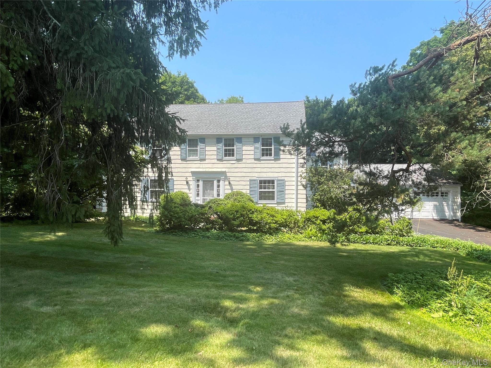 Set on a sought-after cul-de-sac lined with charming classic homes, this 1938 Colonial masterfully blends period charm with today’s lifestyle needs. Set on a lovely private acre with flat lawns surrounded by towering trees yet nestled in a neighborhood setting, this 2,715 square foot center hall Colonial home offers 4 bedrooms, 2 full and 2 half baths. The heart of the home is the family room open to the kitchen, featuring a raised hearth stacked stone fireplace, custom built-ins, and a door to the deck and patio. The eat-in kitchen is a chef’s dream, with tile flooring, a large center island, wood cabinetry, glass tile backsplash, and premium stainless steel appliances including a 6-burner Wolf gas range with addt'l griddle and grill, double ovens, and a Sub-Zero refrigerator — plus its own door to the deck. A screened porch offers additional space for indoor-outdoor living.Elegant formal spaces include a living room with fireplace and built-ins, and a dining room with built-in corner cupboards, both showcasing beautiful oak hardwood floors throughout. The primary bedroom suite is a true retreat, with an adjacent sunroom/home office, walk-in closet, and en-suite full bath. Three additional bedrooms and a hall bath complete the upper level.Additional highlights include main floor laundry, a side door entry, ample basement storage, and expansion potential over the garage. Recent updates include a roof just 8 years new, boiler (2015), new windows in the kitchen, family room, sunroom, and 2 bathrooms, 4-zone heat, 2-zone central air, and a portable generator hookup for peace of mind. Cedar shake exterior adds to the timeless curb appeal.Located in the award-winning Chappaqua school district, close to shops, schools and metro North commuter train, this is a rare opportunity to own a piece of classic Chappaqua charm with all the modern comforts today’s buyers demand.
