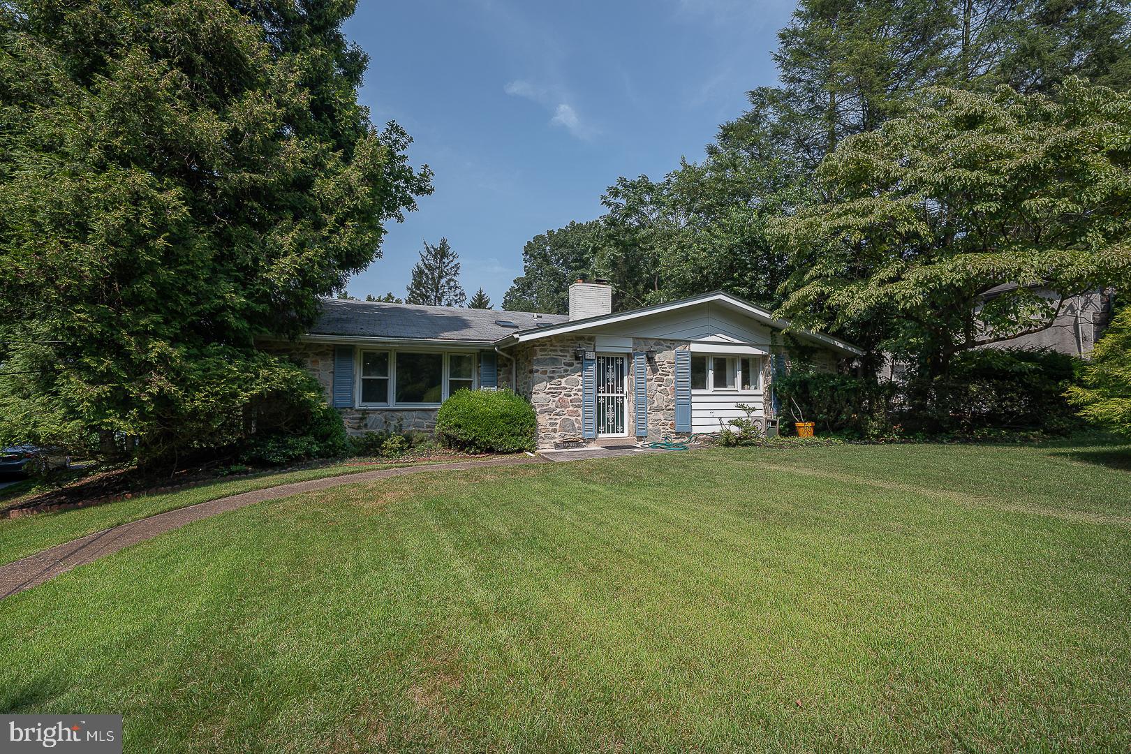 Welcome to 323 Hidden River Road in desirable Penn Valley – a spacious and beautifully maintained 5-bedroom, 3.5-bathroom home nestled on a private 1.23-acre lot in the award-winning Lower Merion School District. With over 4,100 sq ft of living space, this home offers the perfect blend of comfort, style, and function. A foyer with skylights warmly greets you upon entry, leading into a bright formal living room featuring soaring vaulted ceilings. A striking stone fireplace anchors the elegant formal dining room and connects seamlessly to the eat-in kitchen, complete with a breakfast area and convenient access to the back deck. Upstairs, the expansive primary suite includes two closets and a full ensuite bath. Three additional bedrooms and a full hall bath with double vanity and tub complete the upper level.  Down a few steps adds incredible flexibility with a spacious family room with fireplace, two bonus rooms ideal for a 5th bedroom, home office, or gym, plus a full bathroom, half bathroom, mudroom with laundry and outside access, and abundant storage throughout. Step outside to a large back deck overlooking the level backyard – perfect for entertaining, play, or simply enjoying the natural surroundings. Ideally located near major roadways for an easy commute to Center City, and just minutes from shopping, dining, and recreation.Don’t miss this exceptional opportunity to own a move-in-ready home in one of the Main Line’s most sought-after neighborhoods!