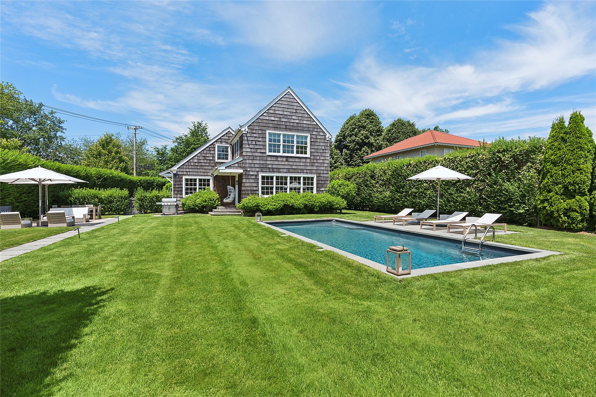 Welcome to Cedar Hedge House, where timeless Southampton charm seamlessly blends with the finest modern luxury. Tucked away behind mature hedging on a beautifully landscaped parcel in the heart of Southampton Village, this impeccably renovated 4-bedroom, 3.5-bathroom cottage offers the perfect balance of privacy, style, and convenience—just minutes from village shops and only a seven-minute drive to the beach.



Renovated by Grisoro Studio with careful attention to detail, every inch of this approximately 2,600 square foot home feels refined and inviting. Sunlight pours into each room thanks to unobstructed exposures, creating a warm and welcoming atmosphere. The open-concept main floor features a chef’s kitchen with quartz countertops, brand-new Bosch appliances, and seating for up to 16 guests—ideal for weekend entertaining. A custom fireplace anchors the living area, where a bespoke inset television adds sophistication and function. With 10 well-placed closets, there's abundant storage for beachwear and beyond.



Up the handcrafted steel staircase, the expansive primary suite stuns with soaring 20-foot vaulted ceilings, a serene private sitting room, and sweeping views of the grounds. Three additional guest bedrooms provide comfort and style, each with picturesque outlooks and ample space for family or friends.



Outside, your private oasis awaits. Relax poolside by the heated saltwater pool or enjoy friendly competition on the professional-grade putting green. The cabana, outdoor shower, portico, and charming shutters add classic Hamptons touches, while bluestone walkways and app-controlled landscape lighting create an effortless al fresco ambiance. Grill, dine, and unwind under the stars with a backdrop of manicured greenery and the ultimate in outdoor living.



With an expanded parking area for four vehicles and elegant curb appeal, Cedar Hedge House is more than just a weekend retreat—it's a lifestyle. Comfort meets sophistication, design meets practicality, and privacy meets prime location.



This is Southampton at its finest.
