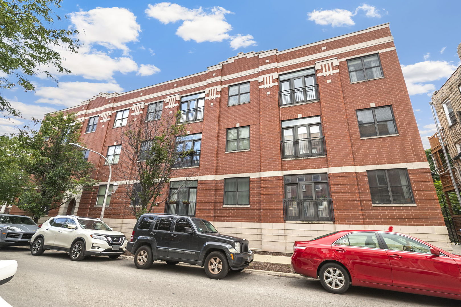 Rare opportunity to own a 3-bedroom + den, 2-bathroom penthouse in a highly desirable boutique elevator building in vibrant Logan Square. Enter through a formal foyer that opens to a spacious kitchen, dining, and living area-ideal for entertaining. The kitchen features granite countertops, modern white 42" cabinets, a breakfast bar, and stainless steel appliances, with natural light highlighting the beautiful hardwood floors throughout. Off the kitchen is a den with built-in bookshelves and desk, perfect for a home office, along with a large third bedroom. A hallway leads to the primary suite, passing another bedroom, full bathroom, and laundry closet. The primary suite boasts a newly renovated bathroom with both shower and tub, a huge walk-in closet, and ample natural light. This end-unit penthouse offers excellent privacy, a split-bedroom layout, and sits elevated above the treetops. Included in the price is an exterior parking space, with an additional private garage space for $20K. The professionally managed building features a secure ButterflyMX entry system and is located on a quiet, tree-lined street. Enjoy proximity to Logan Square and Bucktown's best restaurants, coffee shops, shopping, the 606 trail, top-rated parks, and convenient access to the Blue Line and expressway-making this a commuter's dream and a truly perfect fit.