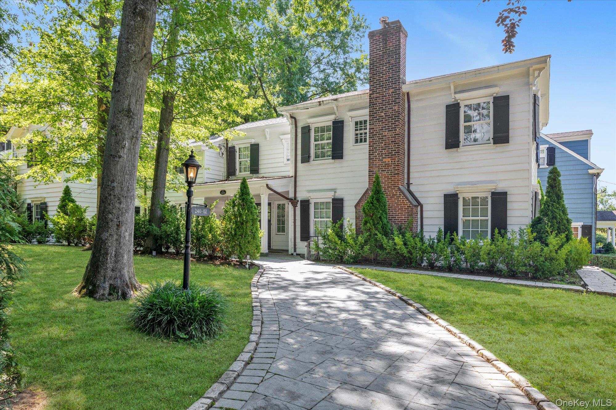Douglaston Hill Historic Landmarked 5-bedroom 3.55 bath colonial over 3000 feet, on over a quarter acre of property. Built in the 1830's and moved to its current location in 1927. Across from Catharine Turner Richardson Park. The interior was thoroughly updated in 2016. 1st floor: Grand entry foyer, living room with wood burning fireplace, formal dining room, eat in kitchen, 2 half baths. 2nd floor: Primary bedroom with bath, 3 additional king bedrooms, 1 queen bedroom and 2 baths, washer/dryer, office. Pull down attic stairs, gas radiant heat in every room, ductless AC units in every room. 1 car attached garage. Full basement