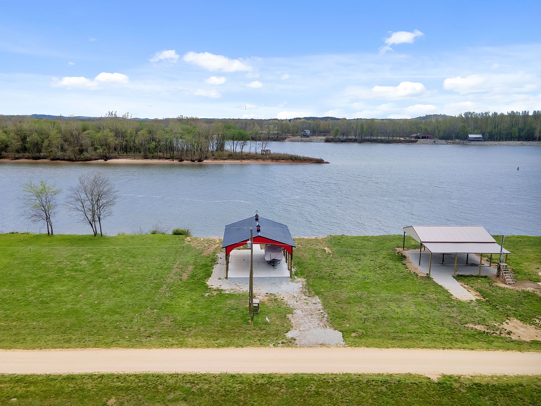 Across from Beech Creek Island. Almost a half acre with 30x40 pole barn. Barn built with 8x8 posts and metal truses featuring 2 coup-alas is ready and waiting for your motorhome. Septic is in. Water is available. Concrete pad is 6" thick with extra rebar. Floating dock in place !