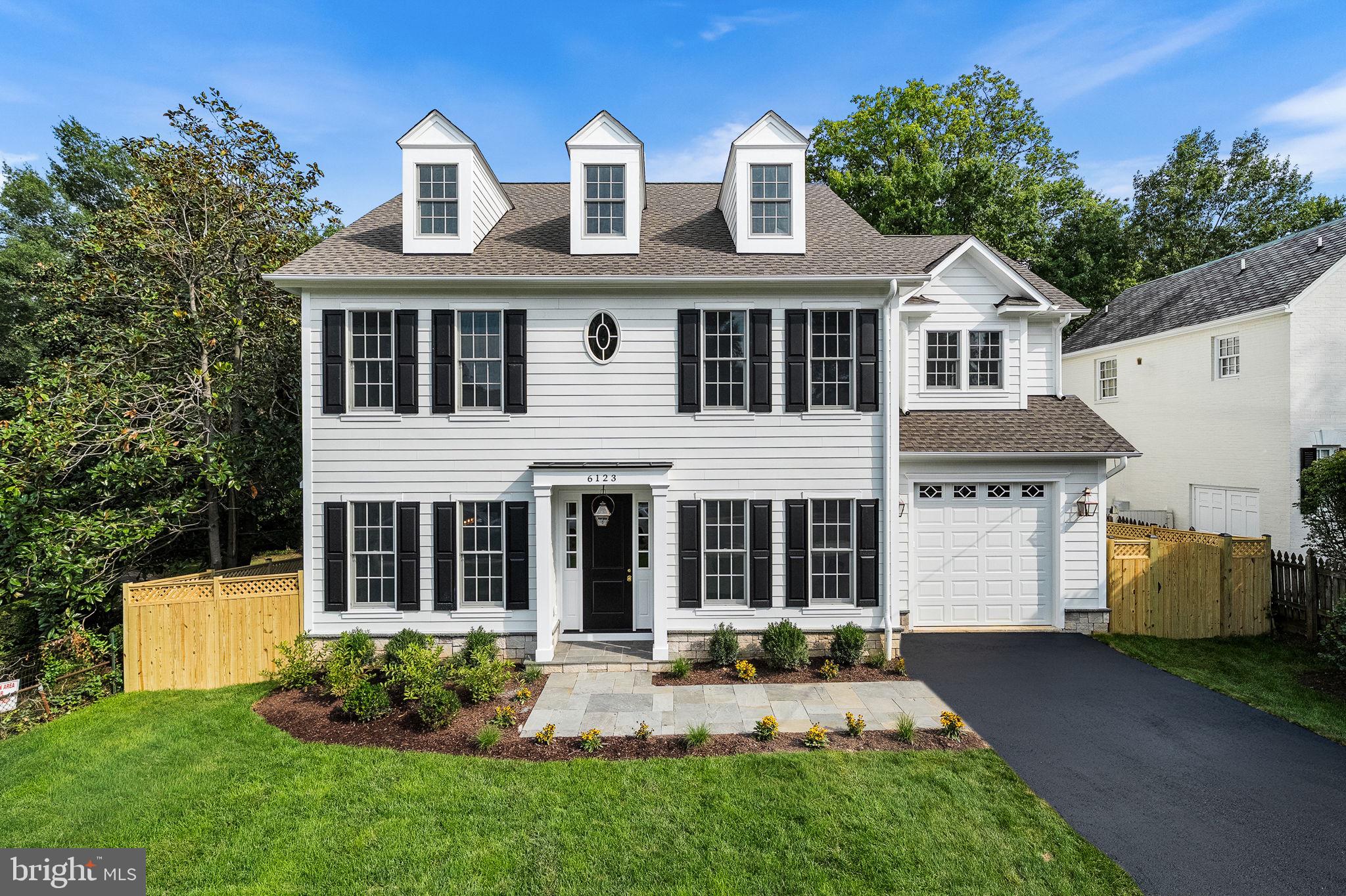 A rare opportunity for all-new construction in the heart of established Belle Haven, 6123 Woodmont Road offers the craftsmanship, scale, and ease of a brand-new residence within one of Alexandria’s most charming neighborhoods. The first entirely new home built here in many years, this exceptional six-bedroom, six-and-a-half-bath residence offers 5,301 square feet across four fully finished levels.Set atop the hill and just one house from Fort Willard Park Circle, the home enjoys an especially desirable setting within a neighborhood known for established homes, tree-lined sidewalks, and a genuine sense of community. The Circle serves as a gathering place for neighborhood events, while traditions including an active garden club and book club reflect the connected lifestyle that makes this pocket of Belle Haven so special.Designed to complement its surroundings, the classic exterior pairs Arctic White James Hardie siding with Dutch Stone accents, black shutters, gas lanterns, and a flagstone walkway. Inside, 10-foot main-level ceilings and 9-foot ceilings on the bedroom and lower levels create beautiful scale. Hardwood floors span three levels, while Andersen 400 Series windows fill the home with natural light. Custom millwork, solid-core doors, polished brass hardware, designer lighting, and thoughtfully selected wallpapers give the interiors depth and personality. Crystal Cabinetry is used extensively throughout, creating a cohesive level of craftsmanship rarely found in new construction.Designed for entertaining and everyday living, the main level includes a dedicated office and dramatic dining room enveloped in Sherwin-Williams Debonaire. The adjoining butler’s pantry features rich cherry cabinetry, quartz counters, brass accents, and open glass shelving, while the jewel-box powder room is wrapped in Thibaut Daintree wallpaper.At the heart of the home, the kitchen features Alabaster Crystal Cabinetry, an impressive 8.5-foot island, Calacatta quartz, marble backsplash, polished brass hardware, an ILVE Italian range, and panel-ready Fisher & Paykel appliances. It opens to a family room anchored by a gas fireplace with full marble surround and double Andersen sliding doors leading to the Trex deck and backyard. A custom mudroom and walk-in pantry add exceptional functionality.Upstairs, the serene primary suite features custom closets and a luxurious bath wrapped in honed marble with Ocean Mist cabinetry, Calacatta quartz, polished nickel fixtures, and a freestanding soaking tub. Secondary bedrooms and baths continue the home’s individualized design, while a beautifully finished second-floor laundry room adds convenience.The fourth level offers a private bedroom with en-suite bath, walk-in closet, window seat with storage, and flexible living space ideal for a lounge, playroom, office, or guest retreat. The walk-out lower level continues the home’s polished aesthetic with a spacious recreation room, wet bar with Crystal Cabinetry and beverage refrigerator, dedicated gym, additional bedroom, and full bath.Outside, flat, fully fenced rear and side yards provide private, usable outdoor space, while the Trex deck with classic Chippendale railing is ideal for dining and entertaining. An attached one-car garage completes the property.More than simply new, 6123 Woodmont Road is a home designed with the details that make a residence feel collected and personal—the rare opportunity to enjoy new construction while embracing the character, sidewalks, traditions, and community of established Belle Haven. A new home designed not simply to be built here, but to belong here.