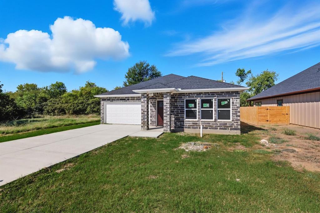 Welcome to 2512 Sheraton Drive in Fort Worth. This beautifully finished 3-bedroom, 2-bathroom home offers 1,513 square feet of living space and a total of 1,994 square feet including a spacious 2-car garage with extra storage. Priced at $230,000 estimated cost to complete construction $35,000, instant equity for the right buyer. It is truly a blessing for a first-time buyer. Inside you will find white shaker soft-close cabinets, granite countertops, premium vinyl tile flooring, and a ceramic tile front entry. Both bathrooms feature upscale ceramic finishes that create a modern and elegant feel. The exterior showcases striking graphite gray stonework, outdoor lighting over the garage and entry, and impressive curb appeal. A private backyard and patio provide the perfect setting for relaxation or entertaining. With thoughtful upgrades, abundant storage, and a welcoming layout, this home delivers comfort, style, and value in a fantastic Fort Worth location.