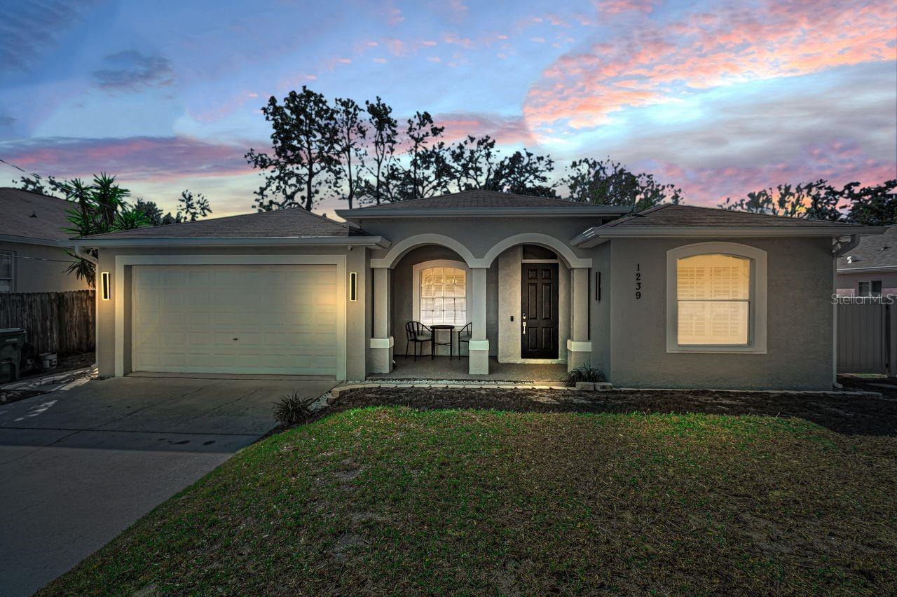 With a full-price offer, sellers will install a new roof, AC, and water heater. This approximately 1,800 square foot house offers four bedrooms and two bathrooms. The open floor plan creates a spacious and airy feel throughout the living areas. The spacious primary suite offers a peaceful retreat. The two-car garage provides convenient storage and parking, while the laundry room ensures practical living. The covered front porch welcomes guests, and the vaulted ceilings add grandeur to the interior. The screened-in porch is an ideal space for relaxation or outdoor entertaining, complemented by the fenced yard. Prior to listing, the exterior was freshly painted, and the front lighting has been updated, enhancing curb appeal. Currently utilized as an Airbnb, this property is situated in a quiet neighborhood, making it an ideal living space with income potential.