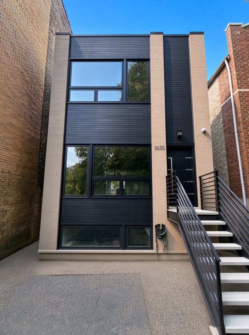 Fully Remastered 4 bed, 3.5 bath single-family home on Humboldt Blvd. Steps away from beautiful Humboldt Park, this New-Construction-style residence was taken down to the studs during the Spring/Summer of 2026 and rebuilt with high-end finishes throughout.  The exterior features modern fiber-cement siding-sleek, highly durable, and fire-resistant. (James Hardie brand) New electrical, plumbing, and HVAC, along with a tankless water heater, new sump system, and HRV ventilation.  The main level opens to stained red oak floors and a wide open-concept living & dining space designed for entertaining. The kitchen is the centerpiece: custom white cabinetry with brass hardware, select glass-front uppers, ceiling-height cabinets, and detailed crown molding. An approximately 10-foot island with waterfall quartz, outlets, matching quartz counters and backsplash, and a full suite of new appliances (French-door refrigerator, range with hood, microwave, and dishwasher) complete the space. Additional kitchen storage and a powder room are on this level.  Upstairs, the primary suite faces the rear yard and includes dual closets plus an ensuite bath with dual vanities, quartz countertops on custom vanities, and heated floors. A second full bath also features quartz counters, heated floors, and a tub/shower. Two additional bedrooms offer strong closet space; the boulevard-facing bedroom brings excellent eastern light and park-side views.  The lower level is finished with abundant natural light and includes a spacious family room, a fourth bedroom with generous closet space, a full bath, and a wet bar with black cabinetry/brass hardware, quartz counter, sink, and beverage cooler. A dedicated laundry room includes stackable machines, counter space, and a sink.    Outdoor living includes a landscaped yard, rear wood patio for grilling and entertaining, and a two-car garage. The front yard offers room for seating along the boulevard. Security cameras are installed. Steps from Humboldt Park, with convenient access to "The 606," Logan Square, Wicker Park, and Bucktown.