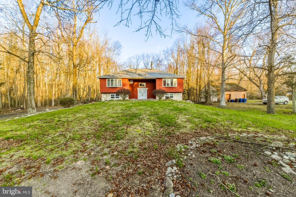 Welcome to 63 Skeet Rd, Medford, NJ, a spacious split-level home offering a flexible floor plan, multiple living areas, and excellent outdoor space. The main entry opens to a central foyer with a convenient coat closet and access to both the upper and lower levels, creating a practical layout with separation between living and private spaces.The main level features a kitchen that flows into the dining area, creating a comfortable setup for everyday living and entertaining. Just off the dining area, there is access to the rear deck/patio overlooking the backyard. Also on this level is a spacious living room with plenty of room for gathering and relaxing.The upper level includes three bedrooms, including a primary suite with its own en-suite bathroom with a shower stall and two generously sized closets. A full hall bathroom serves the additional bedrooms on this level.The lower level opens to a large multifunctional space that can be used as a recreation room, family room, playroom, office, or additional living area. This level also provides direct access to the rear patio and backyard, offering great indoor-outdoor flow. This level also includes two additional bedrooms, along with a laundry/mechanical room with washer and dryer hookups, electric dryer, and electric water heater. Additional storage closets throughout the lower level add to the home’s functionality.Outside, the property offers a large backyard with a concrete patio, a second-story deck with stairs leading down to the yard, and two large storage sheds. Both sheds are equipped with electric service, offering added functionality for storage, workshop use, or other projects.This property is serviced by well and septic, and a septic inspection report is available. With its versatile layout, multiple living spaces, and useful outdoor amenities, this home offers a great opportunity in desirable Medford.