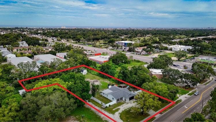 Over an acre of land, a 4-bedroom, 3-bath home, a detached studio, and room to create something truly unique—this property delivers a level of space and flexibility that is nearly impossible to find at this price point. The main home offers more than 1,700 square feet, a 2-car garage, and a functional layout ready for its next owner. Out back, a large barn-style storage building provides plenty of room for tools, equipment, recreational vehicles, or workshop space.The detached 800+ square-foot office, studio, or guest space opens the door for extended family, rental income, a private home office, creative workspace, or future ADU use. An additional rear parcel brings the total property to approximately 1.08 acres and creates a private area set back from the main home with its own potential.Add a pool, create a backyard retreat, explore another guest house or pole barn, build dedicated storage with a private drive, or design a high-income short-term rental experience with outdoor games, a mini golf course, and space for guests to spread out. There is even room to create a dirt bike track, garden, workshop, or recreational area.Live in the main house and use the additional space for income, rent the front property while developing the rear, or simply enjoy the privacy and freedom that comes with owning more than an acre in Largo. The possibilities are extensive, and the value of the land, structures, and future upside makes this one of the most interesting opportunities available in this price range.All future uses, additions, rentals, and improvements are subject to county zoning, permitting, and approval requirements. 2 parcels included in sale.