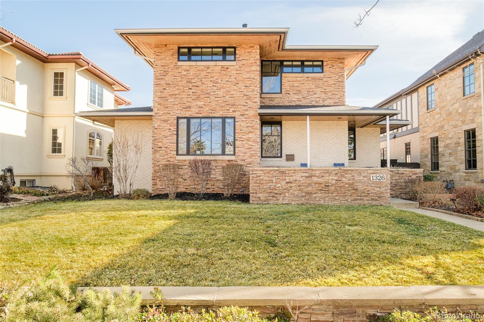 Poised on a picturesque, tree-lined block in Cory-Merrill, this expansive residence pairs timeless elegance with rare functionality. The main level is thoughtfully designed with a private office ideal for focused work, while the light-filled kitchen anchors the home with an open layout, breakfast nook, Wolf range and a built-in Miele coffee machine. A formal living room opens into a sunlit dining area, creating an effortless flow for entertaining. Warmth emanates from a cozy fireplace grounding the spacious main living area. Upstairs, the primary suite is a true retreat, complete with a sitting area, stacked stone fireplace and a luxurious five-piece bath. The finished basement adds versatility with an additional bedroom, rec room and bonus spaces well-suited for a gym or secondary office. Enjoy outdoor relaxation in a fenced backyard with a covered patio. Complete with a rare three-car detached garage, this home offers comfort, space and enduring elegance in a prime location.