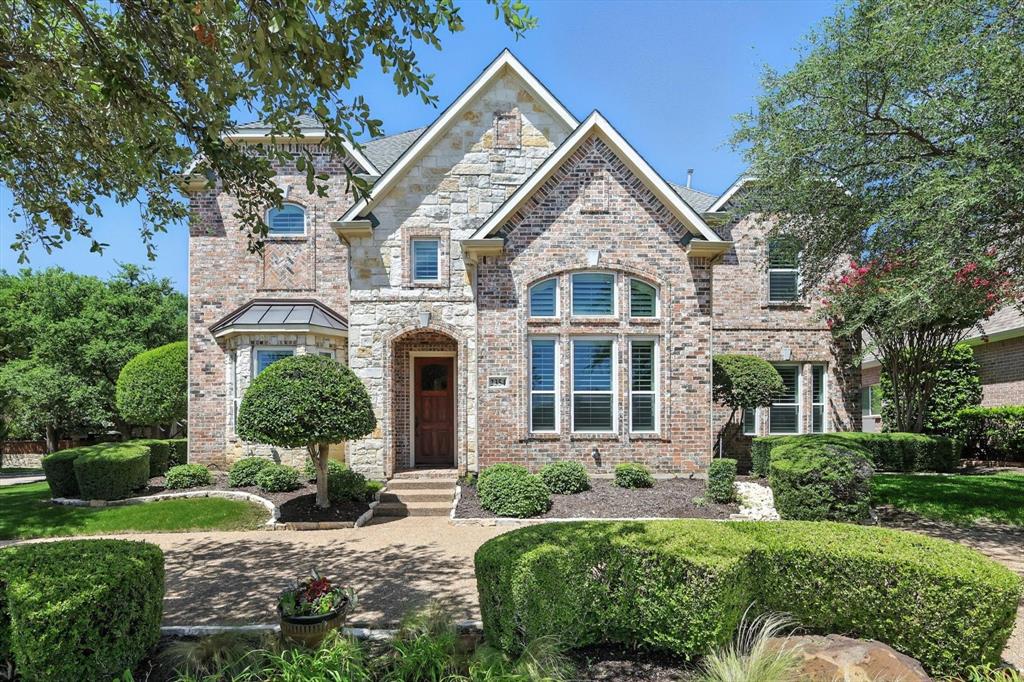 Welcome to 2354 Clearspring Drive N, located in the highly sought-after gated community of Hackberry Creek. This beautifully updated 4 bed, 3 bath home sits on a premium corner lot with circle drive, striking brick and stone exterior, and lush, professional landscaping. Step inside to a light-filled foyer that offers a direct view to the backyard retreat. The formal dining room, wrapped in custom wallpaper, complements a front flex room currently styled as a wine lounge, with views into the kitchen and front yard. The chef’s kitchen features custom cabinetry, a large quartz island with bar seating, marble backsplash, stainless steel appliances, and designer lighting - all flowing seamlessly into the living and breakfast areas with backyard views. The living room centers around a custom gas fireplace with built-in shelving. A private guest suite and remodeled full bath are located downstairs. Upstairs, the spacious primary suite overlooks the pool and boasts a spa-like bath with slate floors, rain shower, jetted tub, dual vanities, and walk-in closet. Two additional bedrooms, a shared bath with separate vanities, and a game room with built-ins complete the second level. The outdoor space is a true retreat, featuring a built-in kitchen with granite counters, bar seating, propane grill, refrigerator, and drawers. A custom motorized louvered pergola with dual ceiling fans and heaters offers adjustable shade and comfort year-round. The resurfaced, heated pool with spa and water feature is bordered by flagstone and Carvestone decking - perfect for entertaining. Additional highlights include an oversized garage with epoxy flooring and bonus storage, plantation shutters throughout, and a downstairs utility room with sink. Hackberry Creek offers three private parks, neighborhood events, and quick access to Hwy's 114, 635, and 161. The community is also within Coppell ISD’s limited open enrollment program. Refined, functional, and move-in ready—this home is not to be missed!