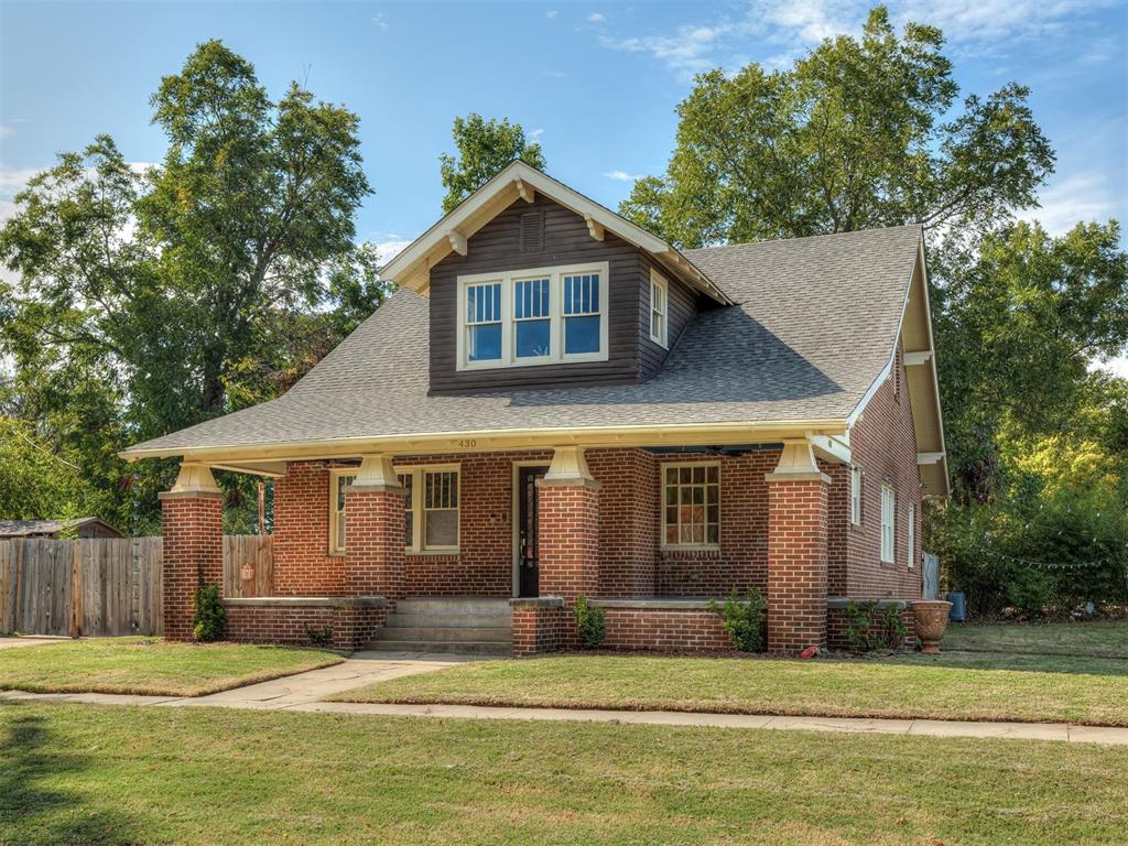 Some homes have character, others have a story worth telling. Built in 1924, this thoughtfully updated home combines original craftsmanship, extensive modern improvements, and a location near the University of Oklahoma and Downtown Norman. Situated on a corner lot, this distinctive two-story home offers 2295 SF, 4 bedrooms and 2.5 bathrooms. Inside you'll find beautifully refinished original hardwood floors, historic woodwork and built-ins, and restored original wood-frame windows - many with hand-blown glass - preserving details that are difficult to replicate in new construction. The redesigned kitchen features custom soft-close cabinetry, granite countertops, a maple butcher-block island, farmhouse sink, beautiful backsplash and exposed brick. There's also a custom pantry and built in refrigerator that stays and a 36" JennAir six-burner gas range and vent hood. The adjoining large dining area has a large built-in that spans an entire wall. Behind the kitchen is the primary suite, which has a custom-designed walkthrough bathroom with gorgeous marble vanities, leading to a walk-in closet. Upstairs you'll find three additional bedrooms with walk-in closets, a remodeled full bathroom and a convenient second-floor laundry (washer and dryer stay). Major improvements in 2021 include complete electrical rewiring with whole home surge protection, plumbing and sewer line replacements, updated dual zone HVAC with individual upstairs smart thermostats, attic insulation, instant hot water with a Navian tankless water heater and a roof with high-impact shingles. An unfinished basement with both interior and exterior access completes the home, offering valuable storage. Enjoy the large covered front porch, wood privacy fence, a location near OU, Main Street restaurants, local shops, and all that Downtown Norman has to offer. An historic home with a century of character, thoughtfully preserved and updated, without restrictions from the Historic Districts.  Schedule a tour today!