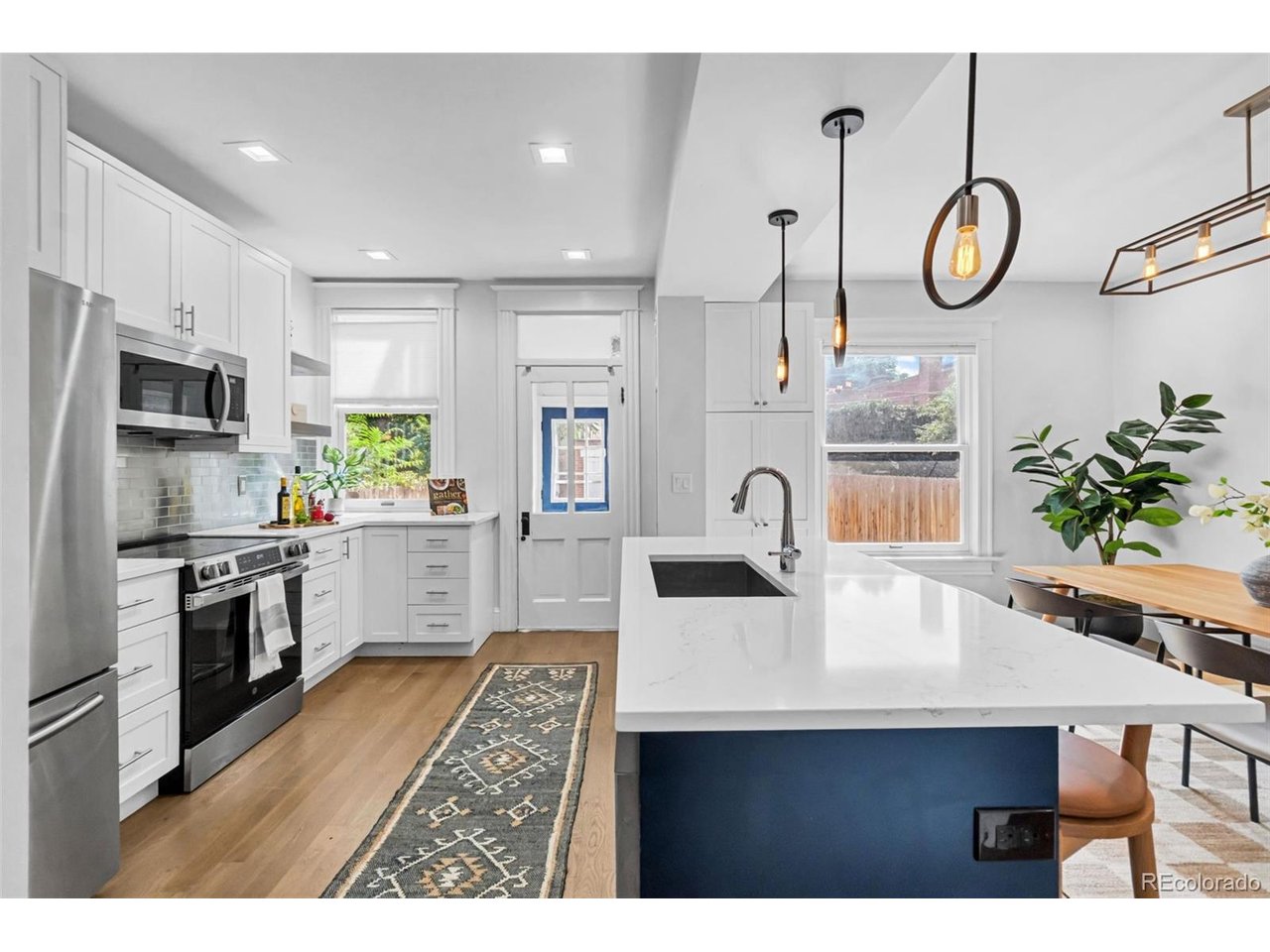 Welcome to this thoughtfully updated home that blends modern comfort w/ character and charm of its original Denver architecture in a historic neighborhood. Updated down to the studs in 2019, the home features updated plumbing, electrical, HVAC and other major systems, offering peace of mind while preserving the timeless details that give this home its personality. The open-concept main level is filled with natural light and showcases beautiful original refinished hardwood flooring, a welcoming front porch, and gorgeous original stained glass. The updated kitchen w/ quartz countertops and a large island offers abundant cabinet and pantry space, making storage and everyday living effortless. A rare and highly functional mudroom provides the perfect drop zone for coats, shoes, jackets and everyday essentials. The finished basement adds flexibility w/ two non-conforming bedrooms, one of which is very spacious. There is also a newly added large 5-piece bathroom already plumbed for a bathtub, allowing the new owner to choose the tub and finishes that suit their style-clawfoot, freestanding, etc. A standout feature is the oversized basement laundry room, which offers an easy opportunity to add a kitchenette and create a true lock-off apartment. Whether used as a house hack, guest suite, multigenerational living space, additional private quarters, or storage, the possibilities are compelling. Outside, the stamped concrete backyard creates a low-maintenance space for relaxing and entertaining, while the detached 2-car garage adds valuable off-street parking and storage. Located just 3 blocks from Cheesman Park, this home offers an exceptional blend of location, flexibility, original character and modern updates. With a thoughtful 2019 renovation, updated systems, abundant natural light, hardwood floors, original stained glass, flexible basement and rare mudroom, 960 N Downing offers the best of classic Denver charm w/ the functionality and peace of mind of a modernized home.