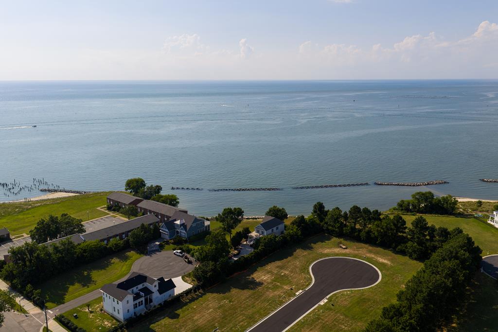 Homesite is less than a block to white sandy beach on Bay Avenue. Located on a small cul de sac off of Washington Avenue overlooking Crystal Lake. Colorful sunsets from westerly elevation. NO HOA. Recorded plat is available with site plan. Variances already given to accommodate non conforming lot.  5604 square parcel is ready for your house plans. Seller is a builder &  has house plans specific to the lot. Cape Charles has become a very sought-after vacation destination offering a beautiful sandy beach, fishing pier, boat ramp, an amazing central park where you can enjoy summer concerts every Saturday night. Lots of shops and restaurants and a historic Palace Theatre offering live shows year-round. 45 minutes from Norfolk, Virginia Beach and Norfolk International Airport.