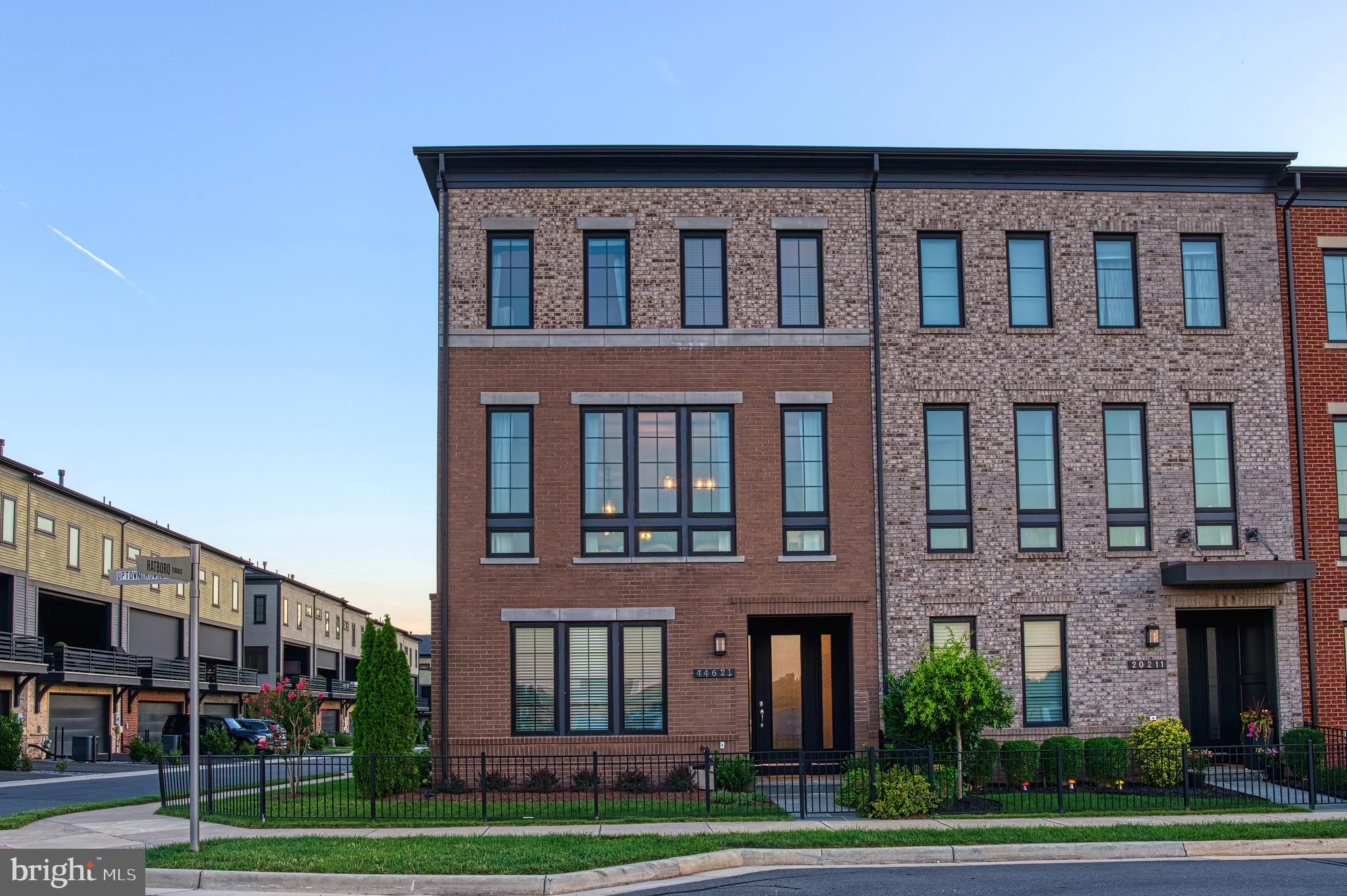 This stunning end-unit brick Miller and Smith townhome is situated in a prime location at One Loudoun backing to green space overlooking a quaint park. It's just a few steps from Central Park, ample shopping, delicious dining, the Club and the Barn at One Loudoun!  This beautifully appointed 4-bedroom, 4.5-bathroom home includes an entry level bedroom with ensuite bathroom that is designed for both comfort and convenience. It features a covered porch with motorized screen, creating the perfect outdoor living space.  Other features include full home water filtrations system, oversized garage that has been enhanced with durable Polyaspartic garage flooring and two 3'x8' motorized storage shelves maximizing both functionality and organization.  Inside, the spacious primary suite includes a thoughtfully updated custom walk-in closet, recently added new gas furnace (2025), whole-house water filtration system (2025) and professionally updated landscaping (2026), all to provide peace of mind and modern convenience.The open floor plan on the main level was created for relaxed living and festive entertainment. With dark hardwood floors, stainless steel appliances, expansive center island with granite countertops and double sliding doors from the great room to the covered balcony.With its premium end-unit location, exceptional upgrades, and unbeatable proximity to One Loudoun's shopping, dining, and recreation, this move-in-ready townhome offers the perfect blend of luxury, convenience, and low-maintenance living.  Enjoy a quick walk to shopping, dining, and entertainment while living in a peaceful, park-side setting.Nearby access to Dulles International Airport, Top Golf, Kincaid, XCal, Silver Line Metro, Washington and Old Dominion Trail, Wegmans, award winning golf courses... and the lush Loudoun countryside bustling with the latest wineries and breweries.