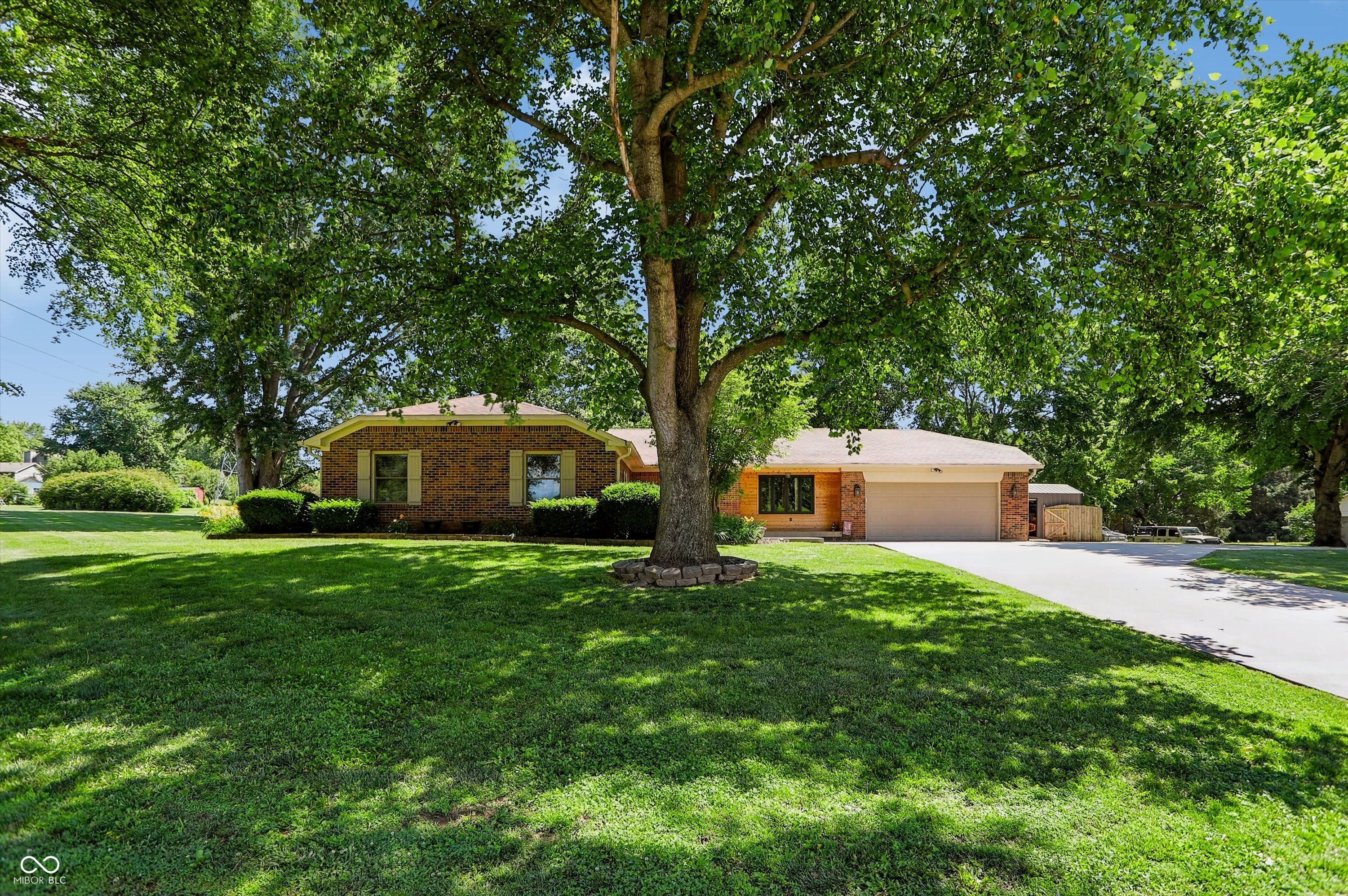 Welcome home to this beautifully remodeled 4-bedroom, 2-bath home offering nearly 2,000 square feet of stylish living space on a gorgeous corner lot of over an acre! With NO HOA, you'll have the freedom and flexibility to enjoy your property the way you want. From the moment you arrive, you'll appreciate the mature shade trees, new concrete driveway, and extended parking area perfect for your RV, boat, trailer, or multiple vehicles. Step inside and be amazed by the extensive updates throughout. The heart of the home is the huge open-concept kitchen featuring top-of-the-line appliances, abundant cabinetry, and a cozy fireplace that creates the perfect gathering space for family and friends. New luxury waterproof laminate flooring flows throughout the home, complemented by modern LED lighting that adds a bright and contemporary touch. Both bathrooms have been completely remodeled with beautiful finishes and updated fixtures, creating spa-like spaces you'll love. The spacious sunroom offers year-round enjoyment and includes a relaxing hot tub, making it the perfect retreat after a long day. Outside, you'll find your own private oasis. The backyard is fully enclosed with a 6-foot privacy fence featuring two double-gate entrances and a convenient walk-through gate, providing easy access for trailers, recreational vehicles, and outdoor projects. Entertain guests or relax on the large stamped concrete patio while enjoying the expansive yard and mature trees. A newer storage shed with drive-out ramps provides ample space for tools, equipment, and hobbies. Additional upgrades include a tankless water heater, new concrete driveway, updated LED lighting, luxury waterproof flooring, and countless improvements that make this home truly move-in ready.