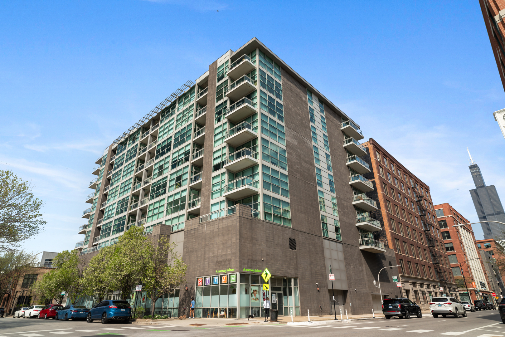 Spacious and sun-filled 1-bedroom + den condo in the heart of the West Loop! This east-facing unit features floor-to-ceiling windows, hardwood floors throughout, and a large private balcony with incredible city and rooftop views. The open-concept layout includes a welcoming foyer with a coat closet, a versatile den area perfect for a home office, and a generous living/dining space ideal for entertaining.    The modern kitchen is outfitted with sleek Italian cabinetry, light quartz countertops, stainless steel appliances, and ample storage. The oversized bedroom includes a walk-in closet with custom built-ins, while the spa-like bathroom offers a soaking tub, walk-in shower, and a large vanity with storage.    Additional features include in-unit washer/dryer, custom solar shades, and a floor-to-ceiling storage cage. This well-maintained, elevator building offers door staff, a fitness center, and low monthly assessments that cover heat and gas. Attached garage parking available for $30,000.    All of this just steps from the best of the West Loop-award-winning restaurants, cafes, nightlife, shops, grocery stores, and multiple transportation options. Perfect as a primary residence, a pied-a-terre, or an investment property. Be sure to check out the virtual tour with photos, walk-through video, and floor plan!