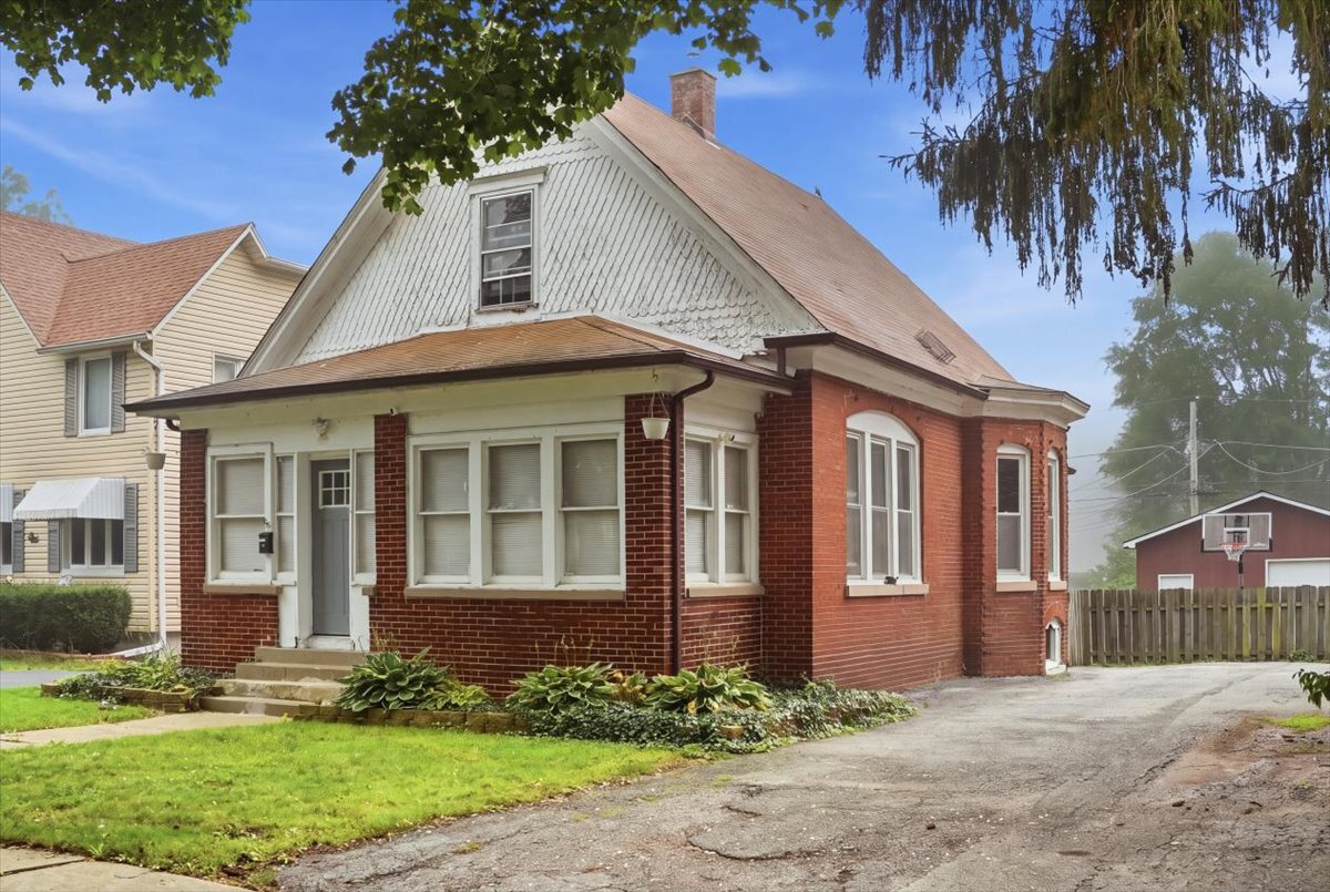 Built in 1906 and lovingly updated over time, 2915 Enoch Ave is full of the kind of character you just can't find in newer homes. A charming front porch welcomes you inside, where tall ceilings and an abundance of windows make the home feel even bigger than the square footage suggest. The main floor was remodeled within the past six years and features new flooring, a spacious eat-in kitchen, an updated bathroom, a comfortable living room, and a dining room with a beautiful bay window that fills the space with natural light. An additional room on the main floor gives you flexibility for an office, den, or guest space, and upstairs you'll find three bedrooms with generous closets. Many of the windows have been replaced, and the 960 sq ft unfinished basement offers plenty of storage or room to grow. Step outside to a fenced yard and the true showstopper: an oversized, pole barn-style garage with garage doors on both sides, ideal for the car enthusiast, boat or camper storage, or anyone who has always dreamed of a really big garage. Priced to sell and sold as-is; conventional or cash only. Homes with this much charm and space don't come along often, so come see it for yourself and fall in love.