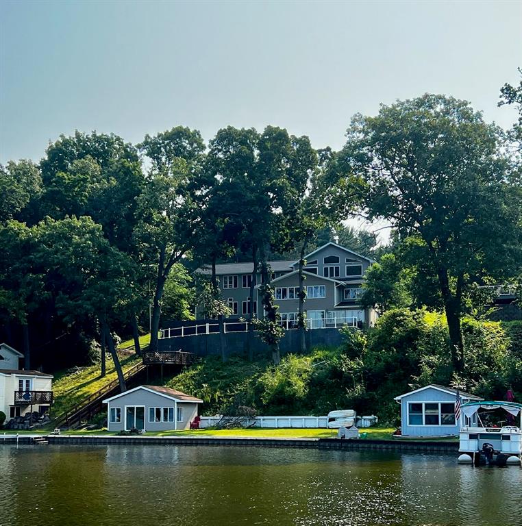 If you're looking for your dream lakefront property that checks all of the boxes, this is it. Spacious 6,027 square foot luxury home on 2.98 acres that features 147 feet of lake frontage on all-sports lake with sandy bottom. Extremely scenic lake views, as the home sits up high, and has huge windows overlooking the lake, & a luxurious patio to sit outside with your morning coffee or enjoy sunsets. No expenses spared & thoroughly renovated in the last 2 years with brand new roof, two furnaces, hot water heater, PEX plumbing, kitchen, baths, patio, railings, insulation, water softener,  garage doors, & recessed lighting. An incredible 41x 20 Great Room overlooking the lake, 5 expansive bedrooms, 3.5 baths, a 3 car attached garage, & an indoor heated pool highlight the interior. The exterior property includes a large yard, a 1 bedroom, 1 bath guest house, a boat house, & a 40x60 pole barn. Great fishing, water sports, & easy access to I-94 to get to Ann Arbor or Jackson quickly.