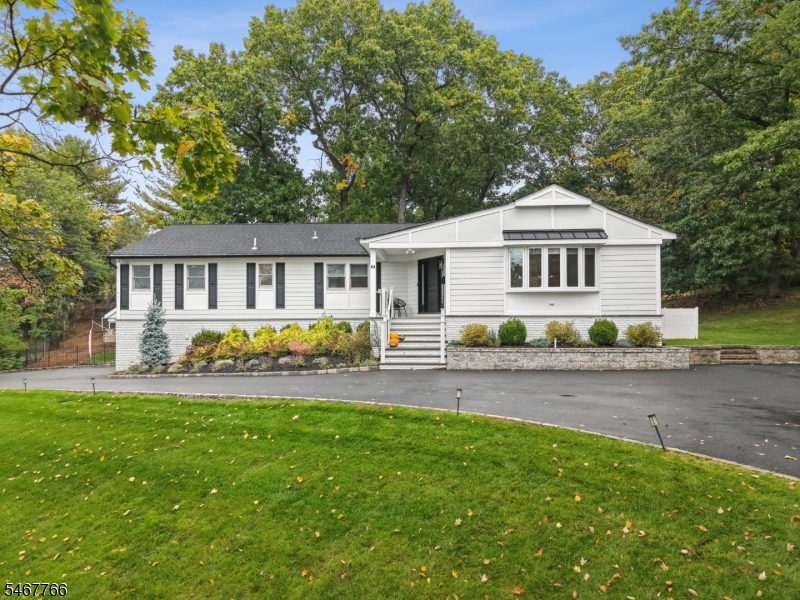 Renovated 5-Bedroom, 3.1 Bath Ranch in Sought-After Riker Hill! Set on nearly .6 acres, this beautifully updated home offers standout curb appeal and almost 4,000 sq. ft. of living space. The main level features nearly 2,700 sq. ft. with formal living and dining rooms, an eat-in kitchen and a family room with a wood-burning fireplace and sliders to the deck overlooking the expansive backyard. Primary suite with walk-in closet and en-suite bath with heated floors. The brand new fully finished lower level adds exceptional versatility, featuring a bedroom, full bath, rec room and wet bar with cabinetry and counter seating ideal for entertaining, guests or extended living space. With generous room to spread out both indoors and out, plus a prime location near top-rated schools, shopping, restaurants and transportation, this Riker Hill home is a must-see!