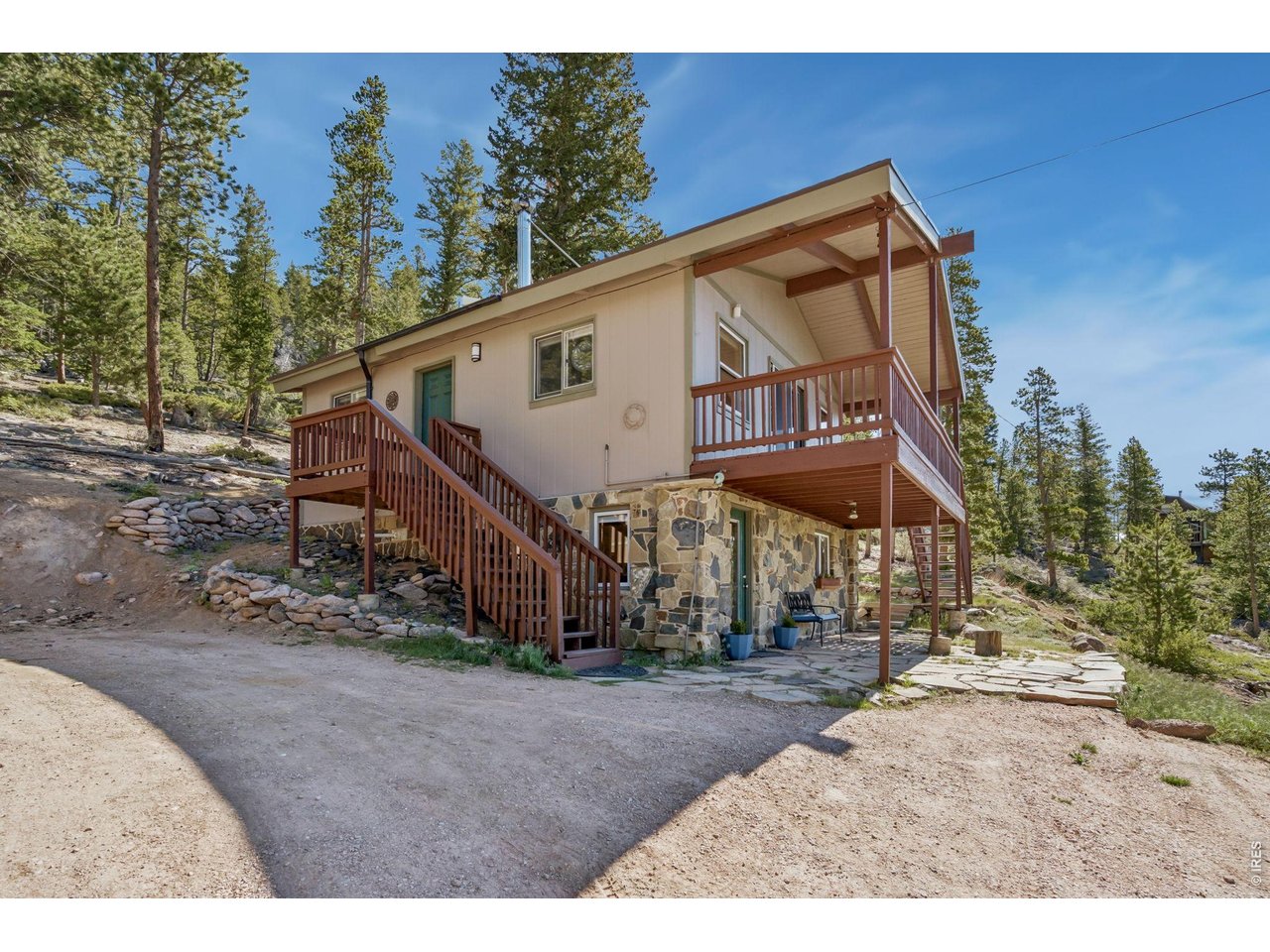 Views, Views, Views! This turnkey cabin offers panoramic views of the Mummy Range and the perfect mountain retreat. The remodeled kitchen, hardwood floors, and tongue-and-groove ceilings and two fireplaces create a warm and inviting, cabin atmosphere. Designed for flexibility, the cabin features two separate living spaces. The finished basement provides flexible space for recreation, hobbies, a home office, or could serve as a third bedroom, along with excellent storage. Enjoy stunning views from the large covered deck or relax on the flagstone patio below. Additional storage is available beneath the deck and in the detached storage shed. Situated on a quiet cul-de-sac, this cabin rests on nearly 2 acres of sloping land featuring impressive rock outcroppings and natural beauty. Enjoy the hiking trails, or canoeing and fishing on the many private, stocked lakes and ponds throughout Crystal Lakes. Whether you're seeking a weekend getaway or year-round mountain escape, this cabin is ready to enjoy. In addition to all the visual upgrades the wall heaters are new, added shed, and excavated for additional parking.