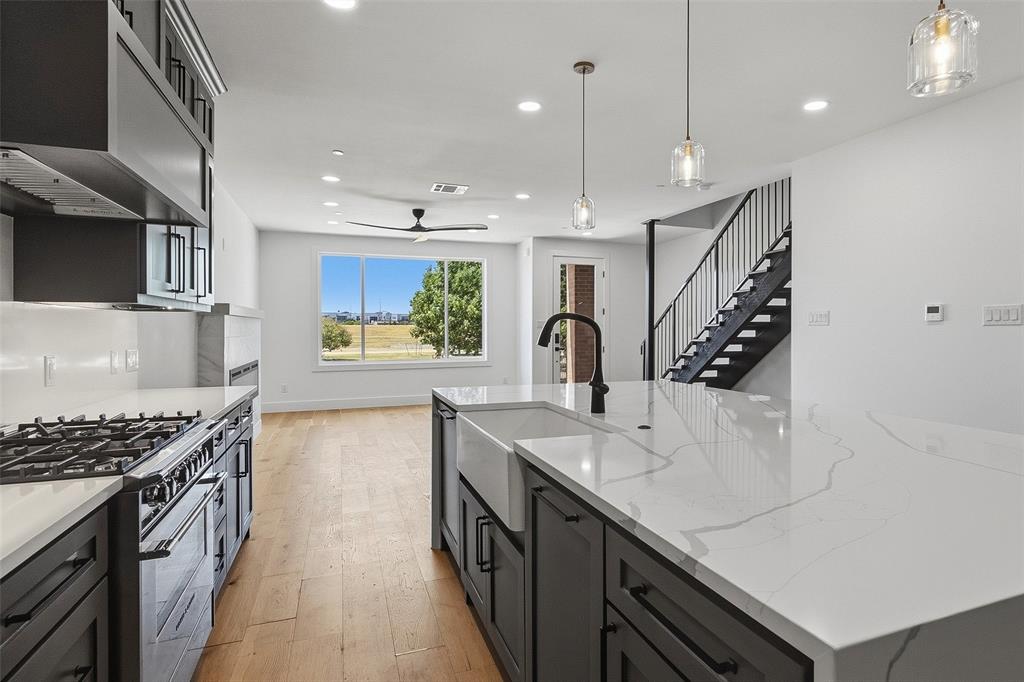 Experience modern riverfront living with spectacular downtown Fort Worth views in this three-story contemporary townhome overlooking the Trinity River. Offering four bedrooms, four full baths and one half bath, the thoughtfully designed floor plan combines elevated finishes with exceptional indoor-outdoor living. The first floor features an open kitchen and living area with a built-in refrigerator, high-end finishes and views across the river. The second floor is dedicated to the spacious primary suite along with an additional en-suite bedroom, while the third floor offers two more bedrooms plus a versatile den or flex space. Step outside to the expansive covered third-floor patio, perfectly positioned for west-facing views toward the Fort Worth skyline and unforgettable sunsets over the river. Additional highlights include multiple outdoor living spaces and a two-car garage with epoxy flooring. All of this in an incredible location with the Trinity Trails just outside your door and Martin House Brewing Company and Topgolf within walking distance—a rare combination of contemporary design, outdoor living and proximity to downtown Fort Worth.