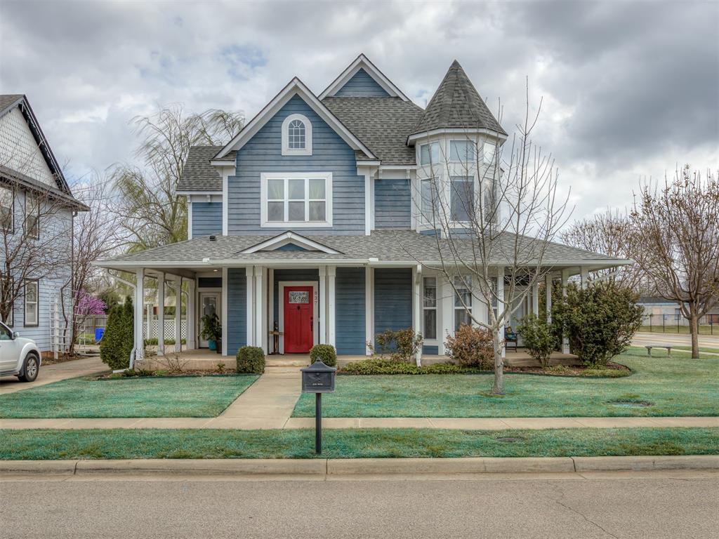 Nestled on a large corner lot in a charming Victorian-style pocket neighborhood in Norman, this beautiful two-story home offers timeless architecture, lovely curb appeal and thoughtful updates throughout. With 3 bedrooms, 2.5 baths, and a dedicated study that could easily serve as a 4th bedroom, the layout provides both flexibility and function.The main level features a spacious open living area with two dining spaces, perfect for entertaining or everyday living. The kitchen is designed to impress with granite countertops, abundant storage, built-in microwave and oven, and a gas range set into the island.Upstairs, the landing features custom built-in bookshelves and a cozy reading nook, adding warmth and character to the home. The entire second floor features new LVP flooring. The primary suite offers a relaxing seating area by the window, separate his-and-hers closets, and a fully remodeled spa-like bath complete with a wet room and stunning clawfoot tub. Two additional bedrooms down the hall share a well-appointed bath with double vanities.Outdoor living shines with inviting wraparound front porches that offer multiple seating areas, perfect for morning coffee, grilling, or relaxing evenings. The large backyard features a pergola, established pollinator garden, and a new vinyl privacy fence. The sprinkler system has been maintained and rerouted to maximize coverage for the oversized corner lot. Additional highlights include a new roof installed in 2021, and an owned and monitored ADT security system.