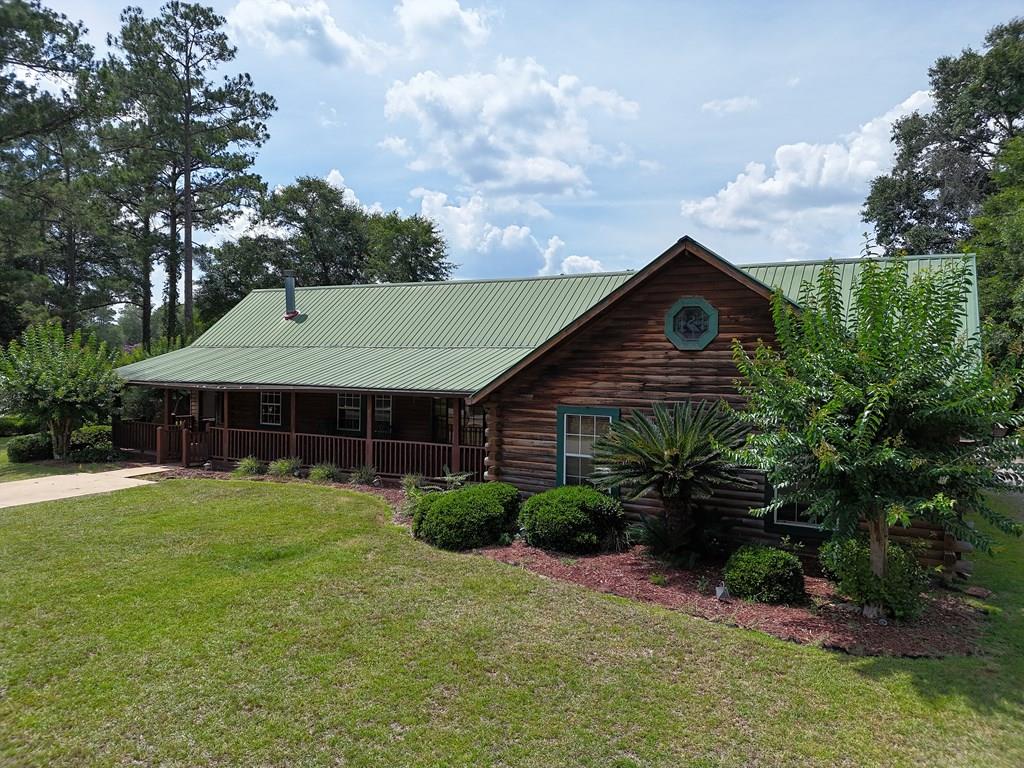 This log home is located off Lake Douglass Road and easilly assessible to all shopping and restaurants.  Inside, you will find a great open living room/dining room/kitchen and a home office that opens out onto your very own backyard oasis. The primary suite is large with a sit-in area and custom stone fireplace, built-in shelves,  attractive wood door and floor to ceiling mirror. The attached bathroom features a luxury shower, double sinks, and a big dressing room that are 2 add'll bedrooms and baths. Outside is where the party's at, with an in-ground pool and 3 covered decks for enjoying music, firepits, dining and chilling! At the front of the house you will also enjoy the big rocking chair  front porch, with fans! Call your favorite agent TODAY for a closer look at this wonderful property!  The house needs a little work, the tankless water heater needs attention and the pool needs work and a new liner.  Have you priced a pool lately?  To get this complete backyard with fencing would probably cost over $70,000.  What a deal!