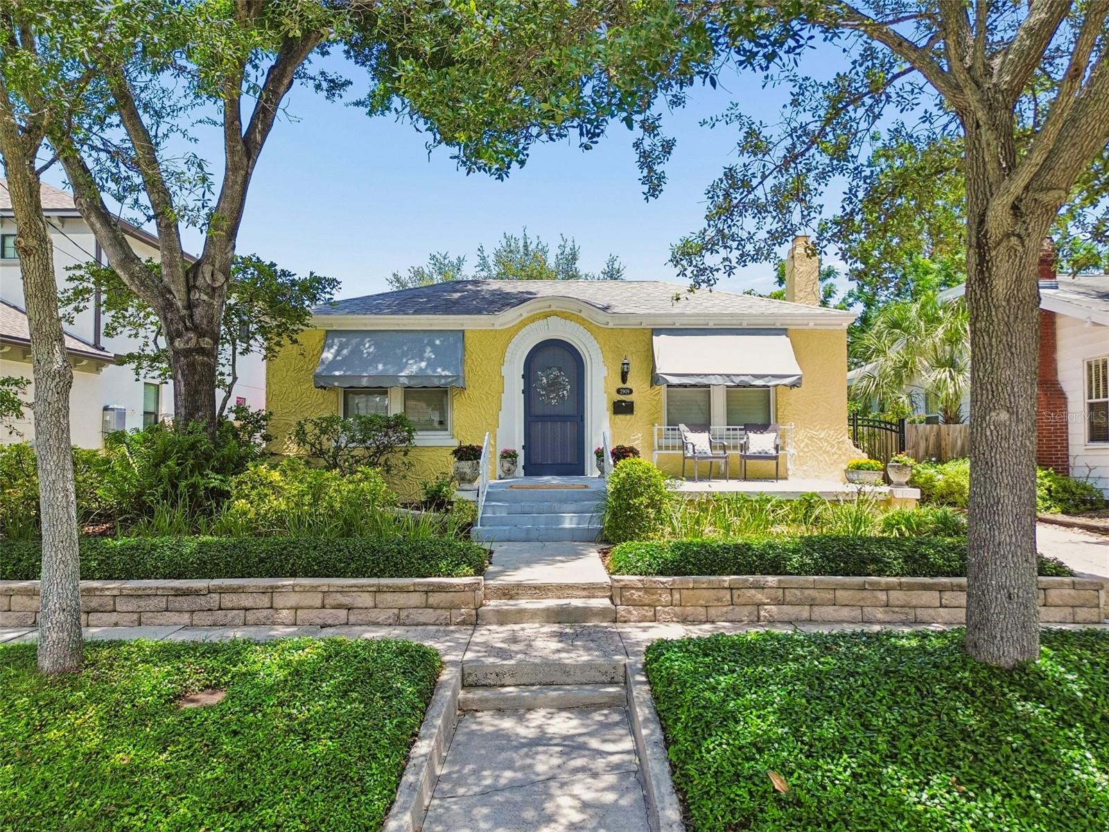 Under contract-accepting backup offers. Ideally in the heart of Palma Ceia on a quiet brick-paved street sits this lovely single-story bungalow filled with timeless character and charm. As you approach the curved front door, be sure to ring the classic original doorbell! When welcomed inside, you will admire the original heart pine flooring, framed windows and doorways, vintage interior touches and a cozy brick wood-burning fireplace, the classic bungalow charm you are expecting. The front windows of the home are historic and original and have been thoughtfully restored to function with ease from top to bottom. Custom plantation shutters are installed throughout the home allowing for an abundance of natural light to seep in as well as the option for privacy. An inviting dining room provides an ideal spot for gatherings and entertaining with friends and family. The updated kitchen is equipped with custom cabinetry, stainless steel appliances, ample storage and granite countertops complete with a breakfast bar. Go inside the cozy Florida room flanked with knotty pine wood walls and ceiling for game-watching parties or simply relaxing after a long day. The serene primary suite is positioned at rear of the home for optimal privacy and includes spacious dual closets, separate linen closet and an updated en-suite bath with large walk-in shower. Two additional bedrooms complete the home and share a classic full bath with octagon mosaic tile. Outside, you'll find a paver courtyard providing the ideal spot for backyard cookouts, a morning cup of coffee and simply enjoying the Palma Ceia lifestyle at its best.  Additional home features include dedicated interior laundry, one-car garage, newer roof (2020), newer air conditioner (2021), newer PGT impact windows (2020) in Florida room and primary suite, updated plumbing (2025), new water heater (2026) and no flood insurance is required. The home is in Flood Zone X and it sits high and dry. Zoned for A-rated schools, Mitchell, Wilson and Plant, and conveniently close to downtown Tampa, Bayshore Boulevard, Hyde Park, Tampa International Airport and just a short drive to beautiful Bay area beaches. Don't miss your chance to own a beautiful bungalow home in Palma Ceia. Schedule your showing today.