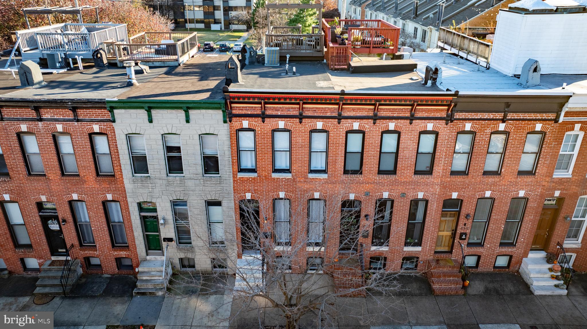 Welcome to 3013 Elliott St! Ideally located in the heart of Canton, just moments from both the Square and the waterfront, this 3-bed, 3-bath home truly has it all - classic charm meets modern updates, a rooftop deck with stunning views, off-street parking, and a finished basement.The main level offers an open floor plan filled with natural light, featuring exposed brick, hardwood floors, a spacious living and dining area, and a gourmet kitchen with natural stone countertops and updated appliances. The kitchen features a newly installed backsplash, a large pantry space, and recently upgraded hardware, lighting, faucet, and glass rinser. Enjoy extra space at the back of the home for a convenient mudroom or sun-drenched office leading to your private parking pad. Upstairs, the charm continues with exposed brick walls, a primary suite featuring an en-suite bath, and a second bedroom also equipped with a private, en-suite bath. Enjoy a multi-level deck leading to the show-stopping rooftop retreat with a pergola and sweeping city and water views. The finished basement with new extra-plush carpet and new blinds includes an additional bedroom, another full bath, and a bonus room - perfect for an office, gym, or guest space. Enjoy the benefits of an extra large washer and dryer and a new, efficient hot water heater recently installed. This Canton home is truly a gem that has been meticulously cared for and loved!