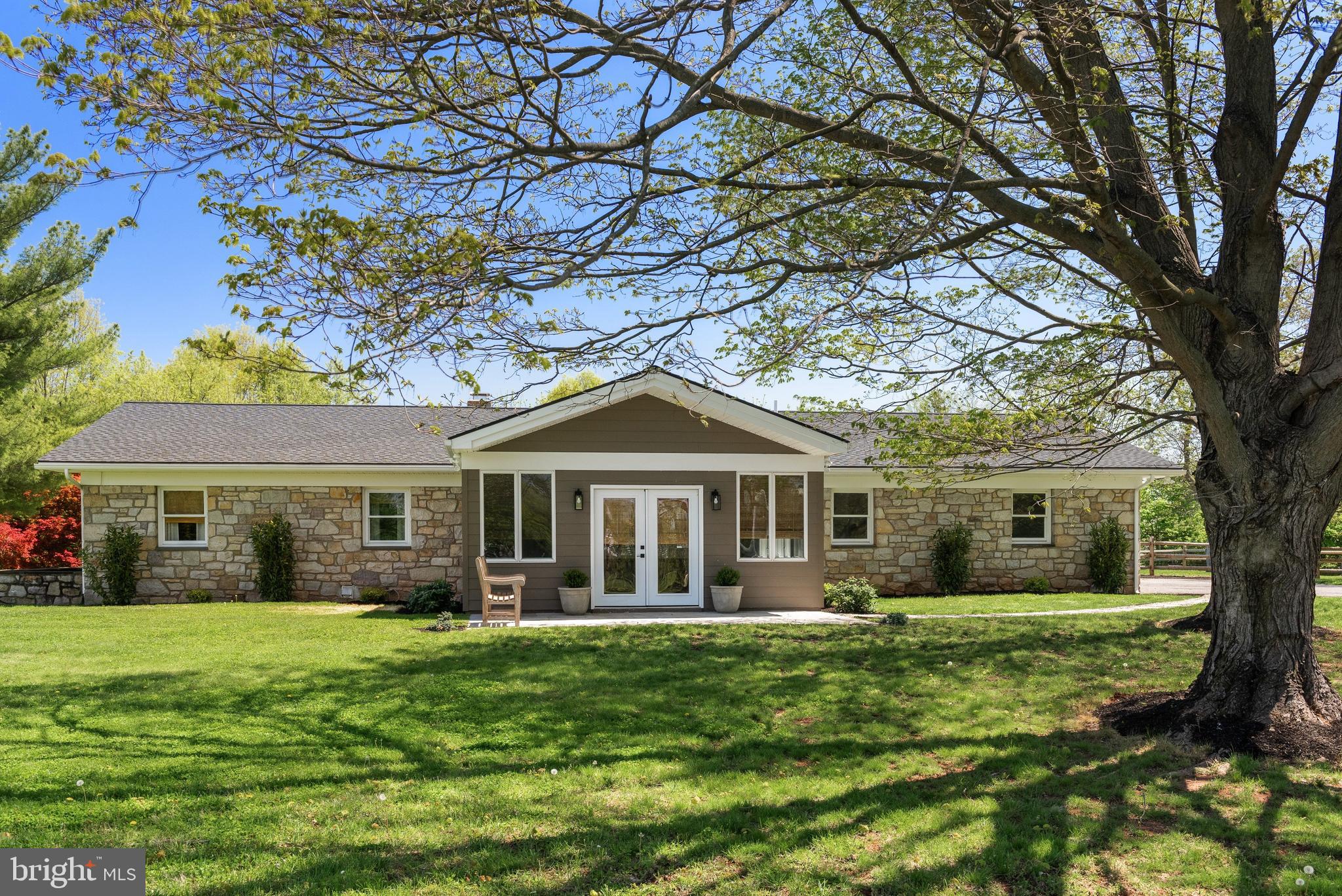 Welcome to 723 Saylors Mill Rd, a truly exceptional property set on 14.3 private acres in Spring City. This fully renovated 5-bedroom, 4.5-bath ranch home offers a rare combination of modern living, expansive outdoor space, and incredible versatility with two large barns. With its generous acreage, the property may also offer potential for Act 319 enrollment, providing an added opportunity for tax benefits. From the moment you arrive, you’re greeted by picturesque surroundings and a sense of privacy that makes this property truly special. Inside, beautiful hardwood flooring flows throughout, complemented by stunning wood-paneled ceilings bringing warmth and character to the main living areas. The welcoming sunroom with heated flooring at the front of the home is filled with natural light and seamlessly leads into the open-concept family room and dining area, complete with a gas fireplace. The thoughtfully designed kitchen is the heart of the home, featuring a large center island with seating, stainless steel appliances, striking countertops and backsplash, and abundant cabinetry. A set of double glass doors just off the kitchen leads directly to the back patio, creating the perfect setup for effortless indoor-outdoor living and entertaining. Just beyond, a comfortable den provides additional living space, highlighted by its own elegant double glass doors. A conveniently located laundry room and powder room complete this area. The bedroom wing offers privacy and comfort, highlighted by a spacious primary suite with built-in cabinetry, direct access to the back patio, and a beautifully appointed en-suite bath featuring a double vanity, soaking tub, walk-in shower, and private water closet. An additional princess suite includes its own walk-in shower, while the remaining bedrooms are generously sized and share a well-appointed full hall bath. The finished lower level adds even more flexibility with additional living areas and a private exterior entrance- ideal for extended family, guests, or multi-generational living. Step outside to your own private retreat, where a fenced-in patio and hot tub create the perfect space to relax and unwind. The property’s two large barns elevate this offering even further with both warehouse apace as well as beautifully finished space offering endless possibilities. With its unique blend of updated living space, expansive acreage, and unmatched versatility, this one-of-a-kind property offers boundless opportunities in a peaceful, private setting. Schedule your private showing today!