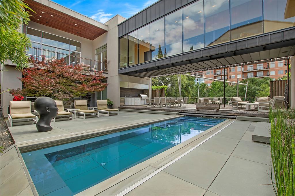 A Modern Architectural Masterpiece in the Heart of the CityDesigned by renowned Bernbaum Magadini Architects, this 12,000 sq ft contemporary estate is a rare blend of architectural innovation and refined luxury. The home showcases clean modern lines, Italian artisan glass mosaics, and an effortless integration of smart-home technology with curated design.A full-size elevator connects all three levels, including a ground-level guest suite with private kitchen and laundry, and a remarkable lower level featuring a 5-car underground garage, state-of-the-art gym with endless pool and water treadmill, spa with wet sauna, golf simulator, and private theater.The main floor is ideal for entertaining, with expansive living areas and a dramatic glass catwalk leading to the secluded primary wing—featuring fully separate his and her baths and closets. Upstairs, enjoy a full outdoor kitchen and rooftop terrace with breathtaking panoramic views.This is more than a home—it’s a lifestyle of privacy, design, and distinction.