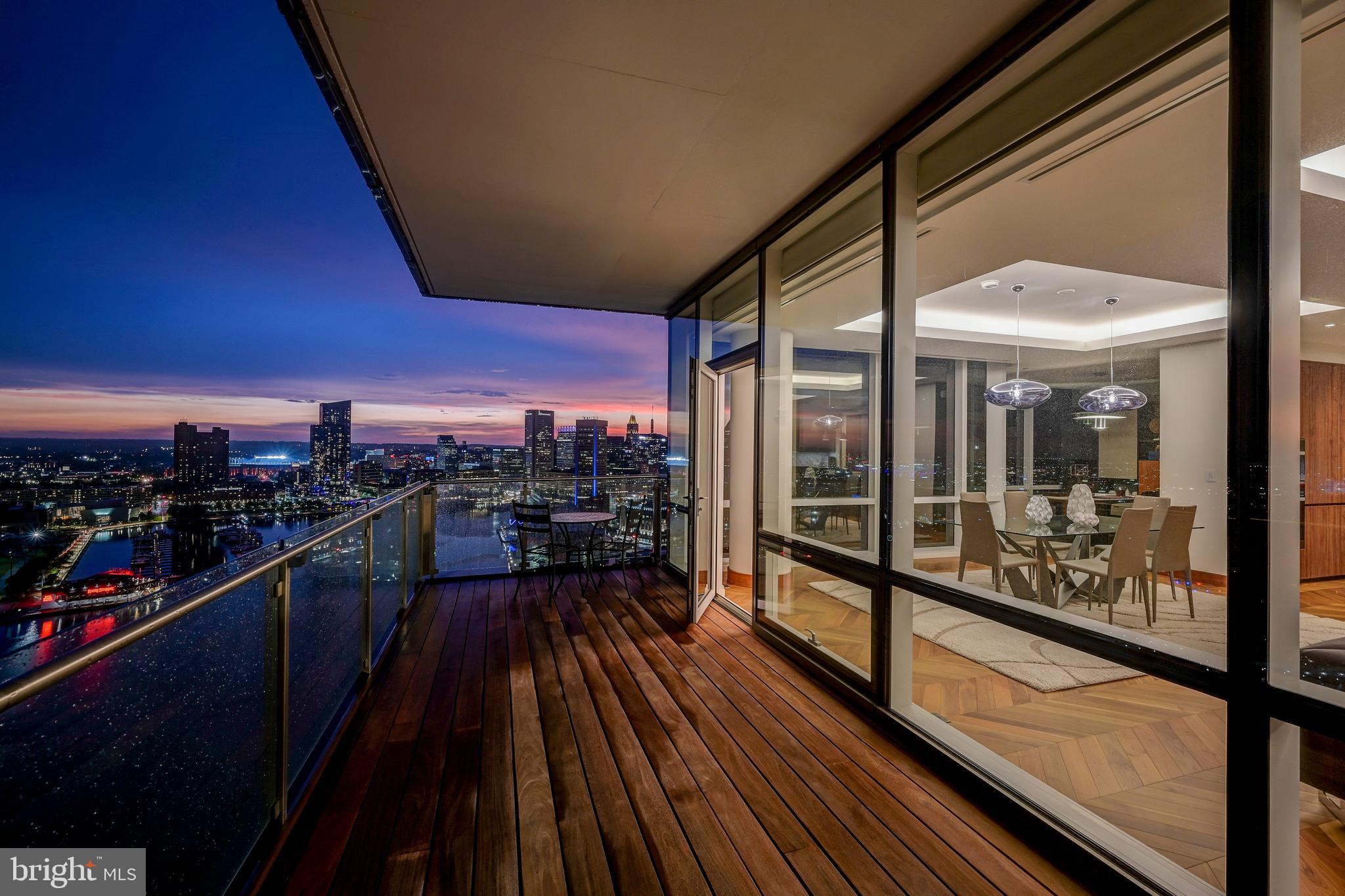 Live amongst the clouds, with the best unobstructed view in Baltimore. Highlighting the epitome of luxury condo living, residence 2501 features 2,200+ square feet oozing with high end finishes and seamless open floorplan. Newly refinished herringbone hardwood floors shine upon entering into the foyer and continue throughout the home. Making the turn towards the living area, floor to ceiling windows allow abundant natural light and the most stunning view of inner and outer harbor to shine through. The Miele appliances compliment a waterfall quartz countertop, two wine refrigerators, a separate ice maker, and double oven with state of the art broiler and heating tray. Find a perfectly sized home office or formal dining area off the side of the great room, which looks over the inner harbor and Baltimore's ever changing skyline. Custom lighting throughout the home accents the vibrant wood cabinets and lively paint selection.  Enter into the owners suite featuring the best views of the condo overlooking the inner harbor. The owners suite bathroom features a large rain shower with designer marble tile, a double vanity with extra counter space, and a comfortable soaking tub. The second full bathroom repeats the luxurious finishes with a rain shower as well as designer marble tiling. Bedroom number two has an equally beautiful view of downtown Baltimore's inner harbor. No expense was spared in the creation of this elegant masterpiece, from the custom window tinting treatments to the Crestron system making this residence controllable with the touch of a button. Tying all of this elegance together is the amenity floor on floor 28 of The Four Seasons Private Residences. A stunning endless pool featuring 180 degree views of Baltimore's harbor sits next to the full gym, oversized common areas ideal for entertaining, and a plethora of other amenities await. Don't miss the opportunity to own one of only 4 units with completely unobstructed views throughout the residence within the Four Seasons Private Residences Baltimore.