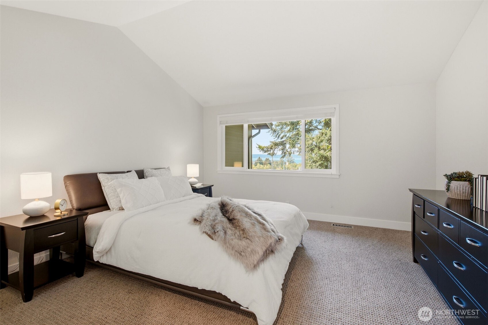 Spacious primary retreat with plush carpeting and a calming atmosphere.