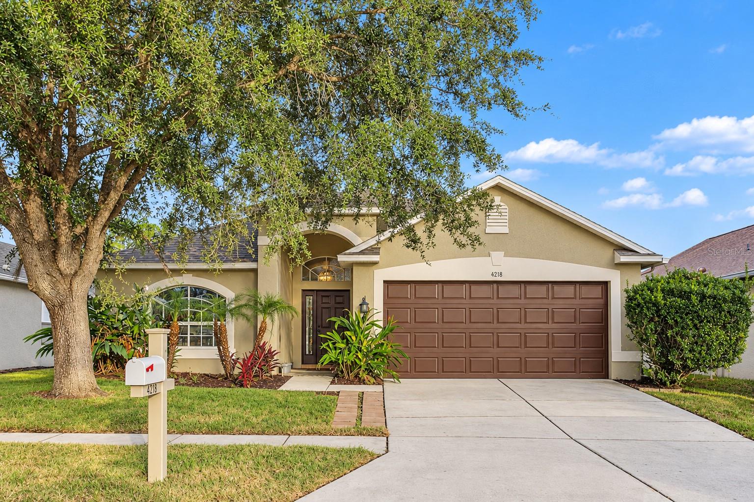 Beautifully renovated CBS block home with a roof under 2 years old, quartz throughout, and new sod, just minutes from Wiregrass.Inside, vaulted ceilings, light oak luxury vinyl plank floors, and new chandeliers and light fixtures with gold accents create a bright, modern feel. The kitchen features Oak Slim Shaker cabinets, quartz countertops, a fluted farmhouse sink, gold plumbing fixtures, a sage stacked-tile backsplash, and stainless appliances. An arched window frames the breakfast nook.The spa-style primary bath offers dual quartz vanities, a garden tub, and a private water closet. Its walk-in, doorless shower has a fluted tile wall and a gold rain showerhead. The guest bath has a geometric tile tub/shower, matte black fixtures, and a door to the exterior. Outside, a fully working irrigation system keeps the new sod green.You’re minutes from SR 54, Wesley Chapel Blvd, Bruce B. Downs, and I-75, with easy access to Land O’ Lakes, New Tampa, and downtown Tampa. Shop and dine at The Shops at Wiregrass and Tampa Premium Outlets, catch a game at Wiregrass Ranch Sports Campus, or spend a day at Epperson Lagoon. The new Orlando Health Wiregrass Ranch Hospital is close by.Move-in ready. Schedule your showing today!