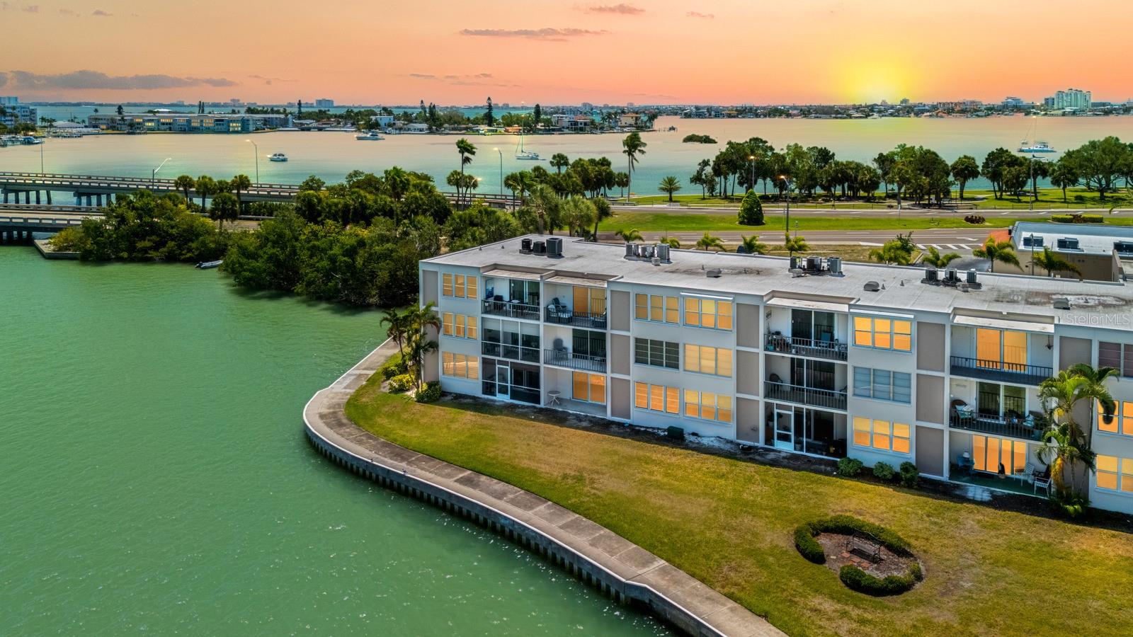 Wonderful water views from both the front and back highlight this top-floor 3-bedroom unit in a secure, quiet, and highly active 55+ waterfront community. Enjoy elevated views and added privacy in one of the most desirable locations in the Bay Islands. This residence offers custom features not commonly found, including a spacious pantry, upgraded lighting, and a beautifully designed lighted divider between the living and dining areas. Take in the Florida lifestyle with scenic walks along the 2-mile seawall, where dolphins and manatees are often spotted, or head to the beach less than 1.5 miles away. The community is rich in amenities, featuring a waterfront clubhouse, fitness center, billiards room, card room, library, sauna and spa, multiple heated pools, tennis and pickleball courts, shuffleboard, BBQ areas, marina access, and a full calendar of social events and activities. Experience resort-style living with endless opportunities for relaxation and entertainment—everything you need right at your doorstep.