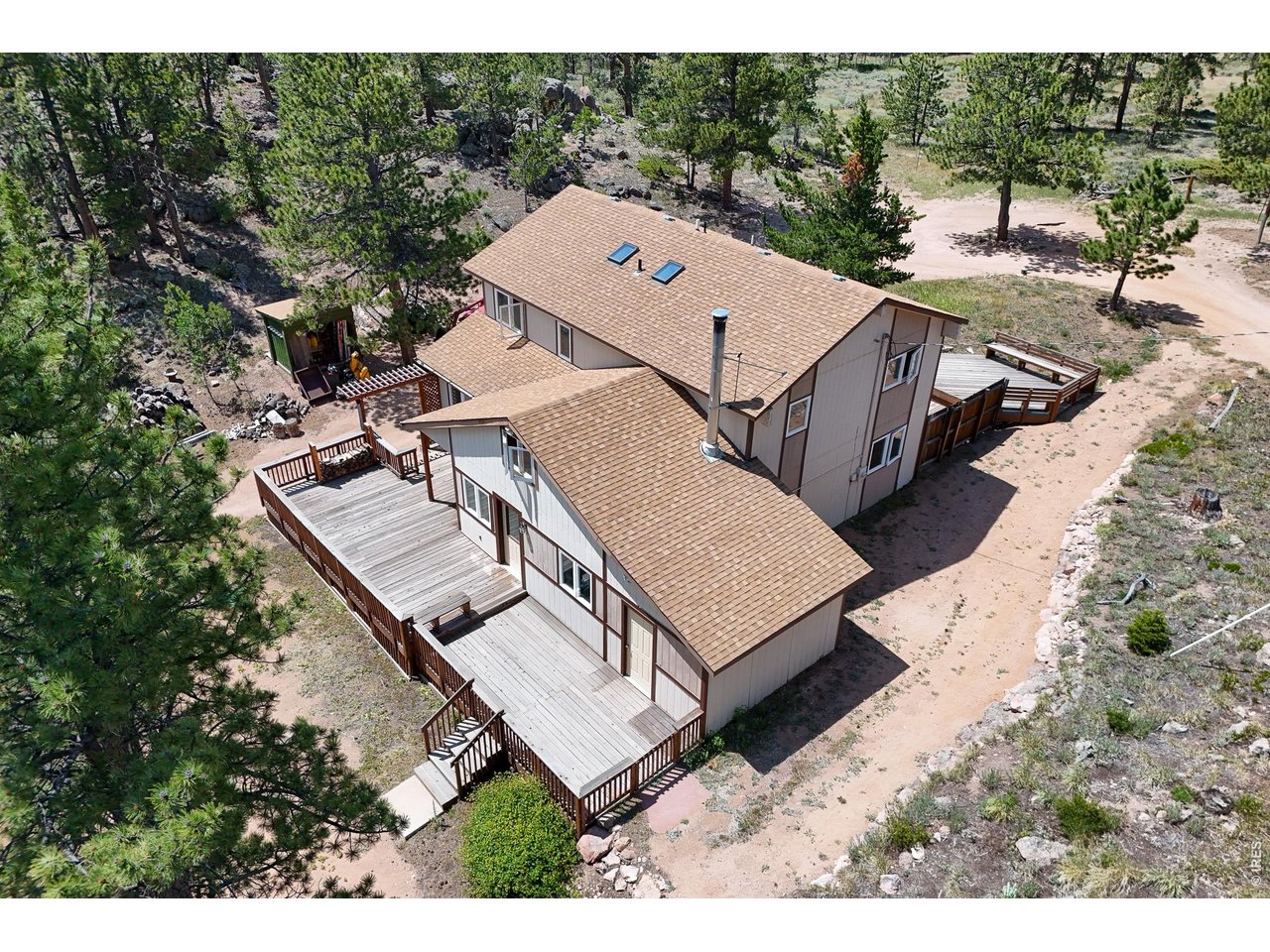 Discover Your Mountain Dream in Red Feather Lakes! Escape to this beautiful warm and inviting mountain home on a quiet cul-de-sac. Surrounded by majestic trees, unique rock outcroppings and great views, this property offers the perfect blend of privacy and serenity for full-time living or a weekend get-a-way. This 4 bedroom, 3 bath home has plenty of space for relaxing, entertaining & enjoying time with family and friends. The main level contains a spacious living room, eat-in kitchen, extra room for a dining table & easy access to the large front & back decks. There is a bedroom, full bath & laundry room on the main floor, too! Upstairs you will find the primary suite with floor to ceiling windows to enjoy the views and stars at night, with an attached bath, a 3rd bedroom & a small dormer bedroom for the littles. The true magic of this home lies in its outdoor features: 2 huge decks to take in the fresh mountain air, entertain or just relax & watch the wildlife go by. There is an attached shed/workspace and a 10x22 shed to store your gear. The land is adorned with wildflowers, pine, and rock-outcroppings, creating a private sanctuary to nature lover's delight. Some finishes are from an earlier era, but it offers solid bones & a fantastic layout for modern updates. Don't miss your chance to create a mountain sanctuary that captures both tranquility and accessibility! Come see it today.