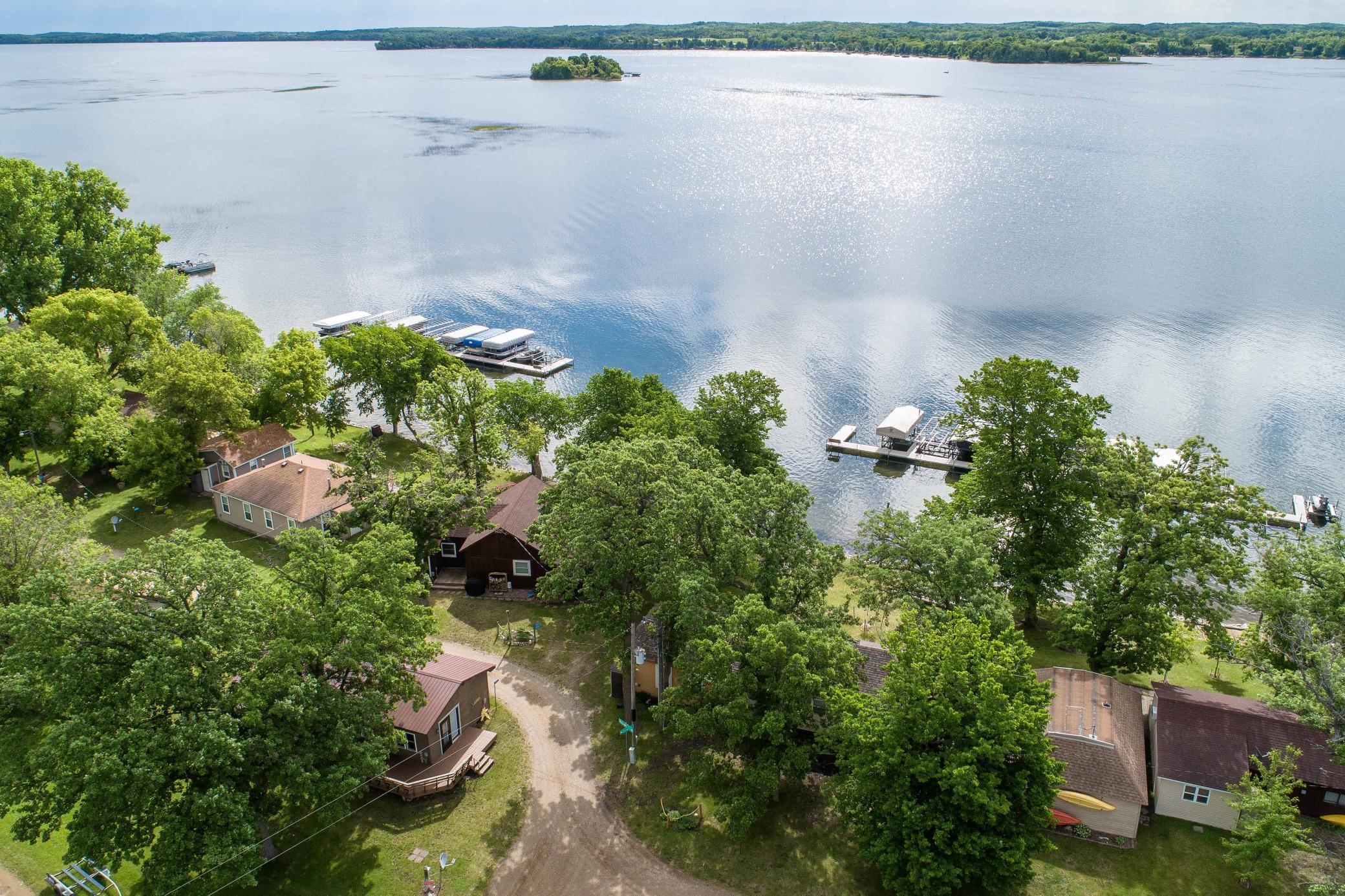 Lake Lida cabin for those seeking relaxation and lakeside living! The shared lake frontage offers the  beauty of the lake without the hassle of maintaining a dock or lawn. The interior features like knotty pine ceilings and walls, wood floors, and an open concept living area create a cozy and inviting atmosphere.  Many updates have been done to the cabin. The outside amenities like the patio, large deck, and storage shed enhance the outdoor living experience. Having laundry conveniently located adds to the ease of staying there. The inclusion of a boat slip, jet ski slip, designated storage area, fish cleaning house access, and parking area for trailers make it easy to enjoy all the recreational activities. And with Lake Lida's reputation for excellent fishing & sandy swimming, it's the perfect place for outdoor enthusiasts.  Overall, this seasonal cabin in the CIC offers a wonderful opportunity for anyone looking to escape to the beauty and tranquility of lakeside living.