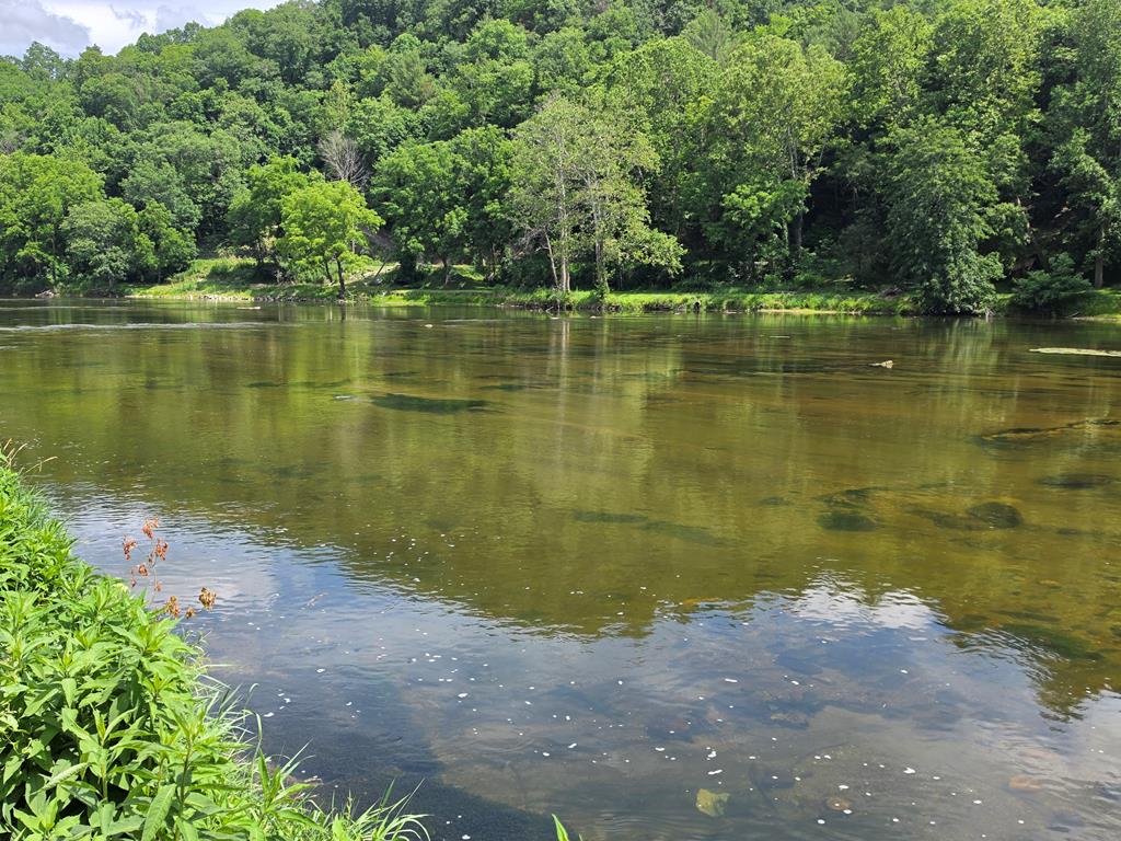 Enjoy river life in the Blue Ridge Mountains with this nice recreational lot on the New River, located along the Virginia and North Carolina state line in the New River Campground. Bring your camper, kayaks, boat, rods and reels, grills, and family, and get ready to relax by the campfire after a day on the water. Whether you enjoy fishing, boating, kayaking, or simply sitting back in a chair and taking in the peaceful river setting, this lot offers a great getaway spot to enjoy all the New River has to offer. Conveniently located within minutes of Independence, VA, Sparta, NC, Grayson Highlands State Park, and more, this property puts outdoor recreation, mountain scenery, and small-town conveniences all close by.