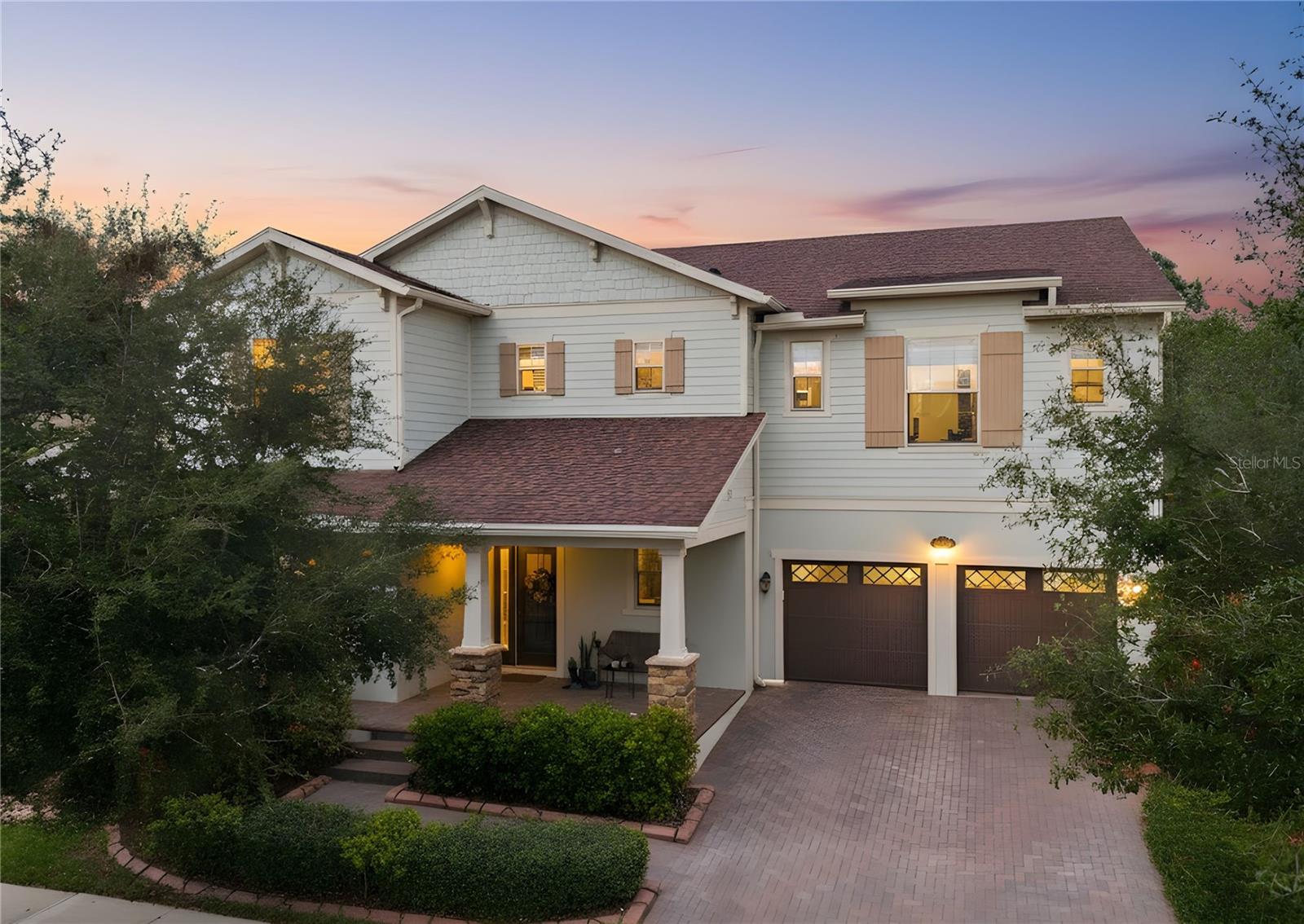 Set within the highly sought-after Windermere Isle community, this exceptional estate offers elevated living defined by space, craftsmanship, and an unbeatable location just minutes from Walt Disney World. Featuring 6 bedrooms, 4.5 bathrooms, and over 4,500 square feet, the home is thoughtfully designed for both everyday living and effortless entertaining.A dramatic two-story foyer creates a striking first impression, highlighted by a custom hardwood staircase with decorative iron balusters. Architectural details continue throughout with 9.5-foot ceilings, 8-foot doors, coffered ceilings, porcelain tile on the main level, and hardwood flooring upstairs. Custom Disney-inspired stained-glass window inserts throughout the home offer a subtle and charming nod to the nearby magic.The expansive open-concept living area is anchored by a chef-level gourmet kitchen featuring a natural gas cooktop, dual convection ovens, quartz countertops and backsplash, oversized island, 42-inch cabinetry, café dining area, and walk-in butler’s pantry—perfect for entertaining and daily convenience alike.The main-level primary suite serves as a tranquil retreat with a spa-style bathroom, soaking tub, glass-enclosed walk-in shower, and generous custom closet. Upstairs, five additional bedrooms include a private guest suite and well-designed shared layouts, along with a spacious upper-level great room and reading nook ideal for a media room, game space, or lounge.Significant upgrades include a 27kW commercial-grade whole-house generator, tankless water heater, gas dryer, advanced humidification and UV air filtration, and a garage with custom cabinetry, overhead storage, and durable polyaspartic flooring. Energy-efficient systems and abundant natural light enhance comfort throughout.