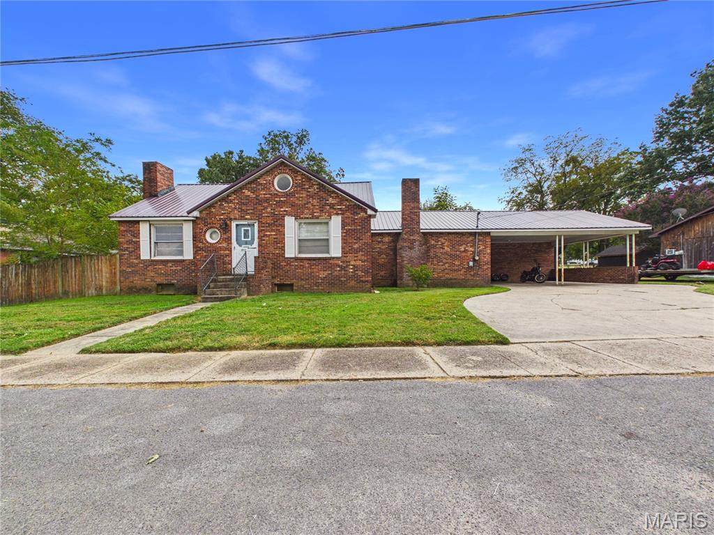 MOVITIVATED SELLER!!!  Well maintained all-brick home located in quiet neighborhood and minutes from downtown. Home has 3 bedrooms and 2.5 baths. Many recent updates with new metal roof in 2025, new carpet in living room, freshly painted,  new bathtub and surround and central heat and air a couple of years old. Large living room with wood burning fireplace. Master bedroom has and fireplace with electric insert. Upstairs has a bonus room could be used as bedroom, home office, playroom area or family room. French doors out of living  room lead to a large covered deck. Back yard has a wooden privacy fence. Downstairs in basement offers lots of storage space for all your needs or make a great workshop area. There is a storage shed at the back of the two car carport for all your lawn care  items and tools. This a great move in ready home just waiting on the right family. Call to today won't last long. More pictures coming soon.